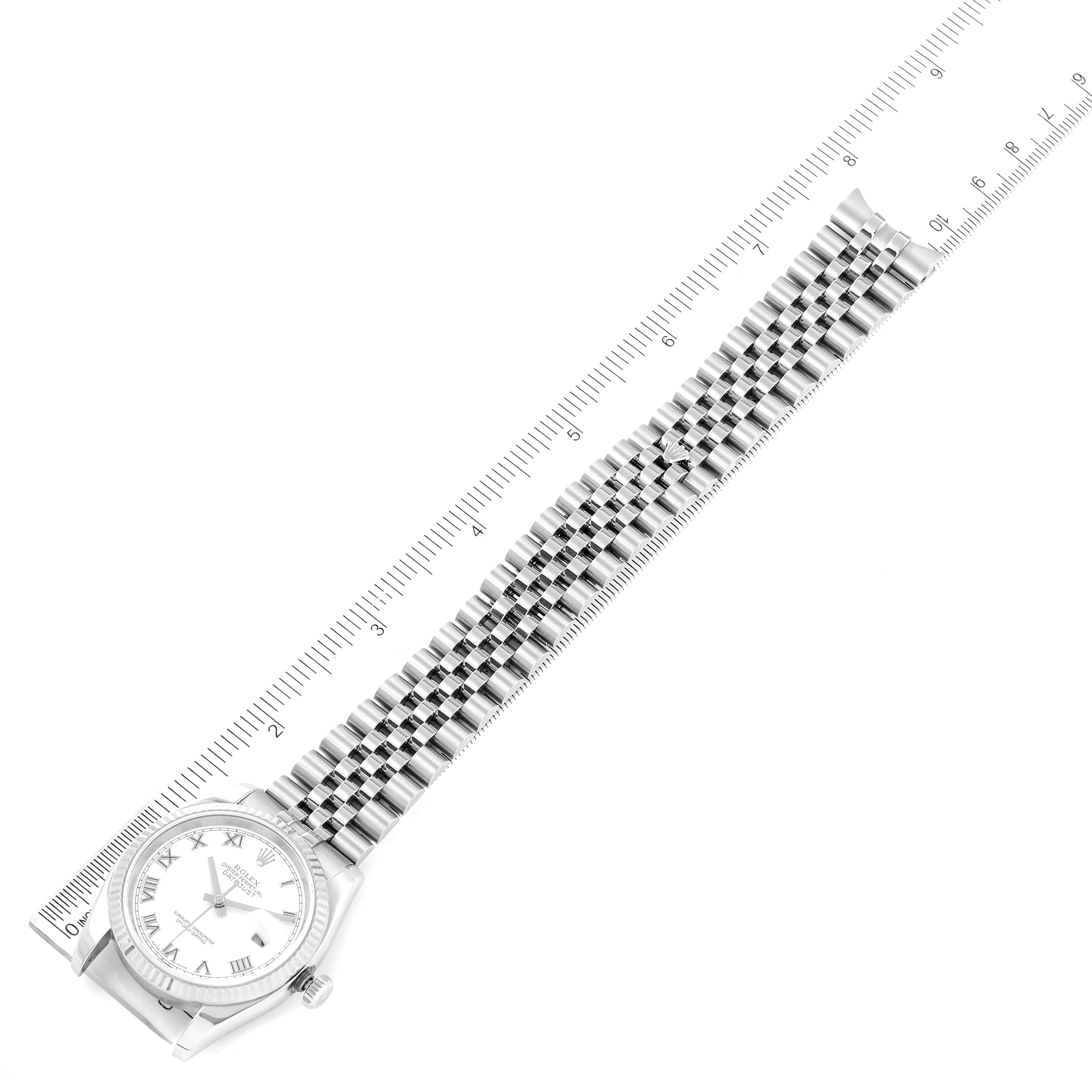 The image shows a Rolex Datejust 116234 Men's Stainless Steel White Dial 116234 Men's Stainless Steel White Dial watch from an overhead angle, featuring its face and metal strap laid next to a ruler for scale.