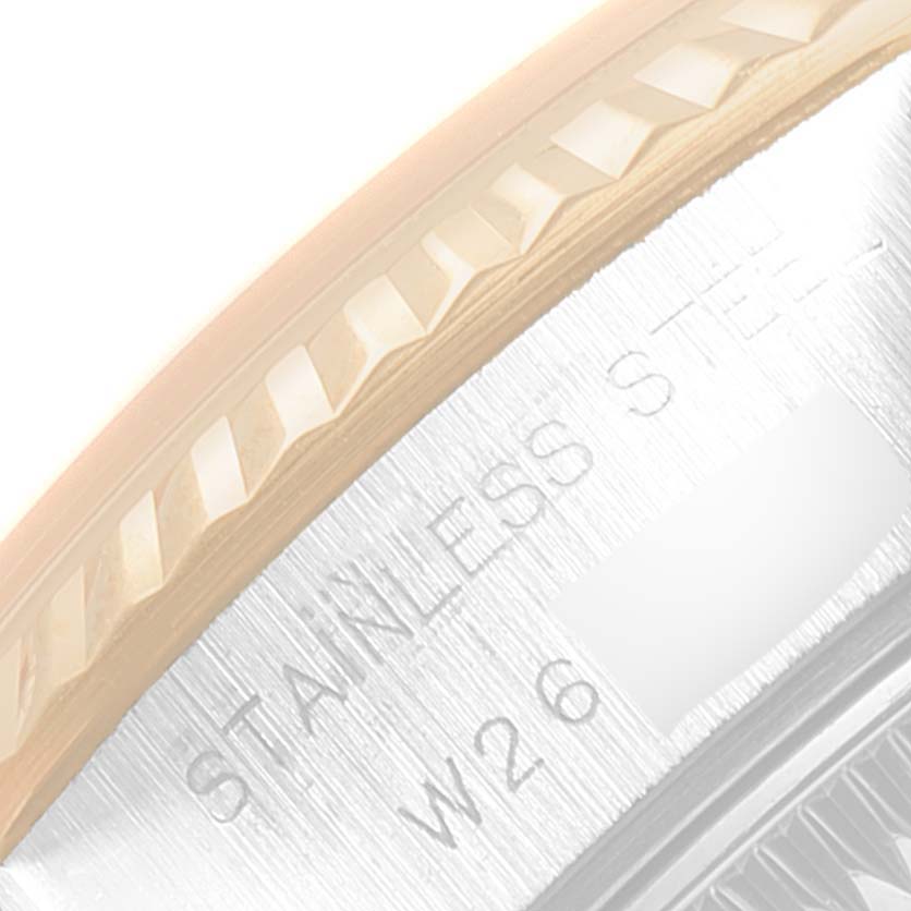 This image shows a close-up of the fluted bezel and case edge of a Rolex Datejust 69173 Women's Steel and Gold (two tone) Black Dial 69173 Women's Steel and Gold (two tone) Black Dial watch, with "Stainless Steel" engraved.