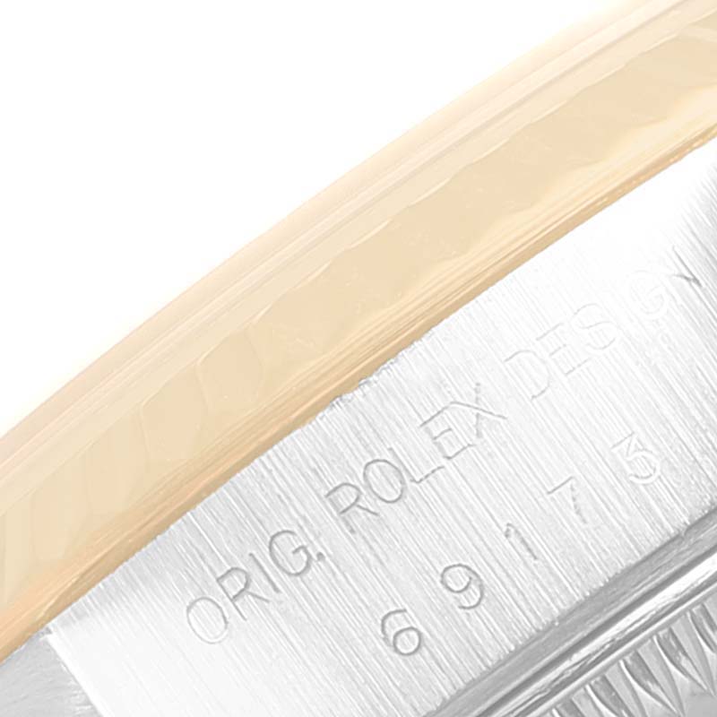 This image shows a close-up of the rim and engraved details of a Rolex Datejust 69173 Women's Steel and Gold (two tone) Black Dial 69173 Women's Steel and Gold (two tone) Black Dial watch.