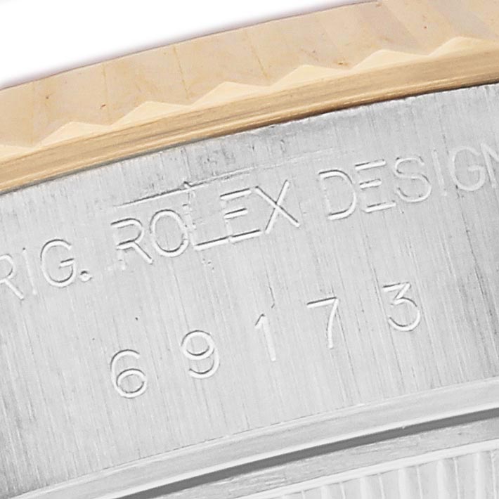 The image shows a close-up of the case side of a Rolex Datejust 69173 Women
s Steel and Gold (two tone) Champagne Dial 69173 Women
s Steel and Gold (two tone) Champagne Dial, highlighting the engraved model number and design details.