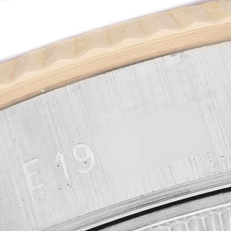 The image shows a close-up of the edge and serial number engraving on the bezel of a Rolex Datejust 69173 Women's Steel and Gold (two tone) Champagne Dial 69173 Women's Steel and Gold (two tone) Champagne Dial watch.
