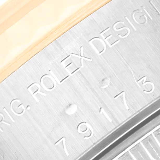 This image shows a close-up of the serial number engraving on the casing of a Rolex Datejust 79173 Women's Steel and Gold (two tone) Champagne Dial 79173 Women's Steel and Gold (two tone) Champagne Dial watch.