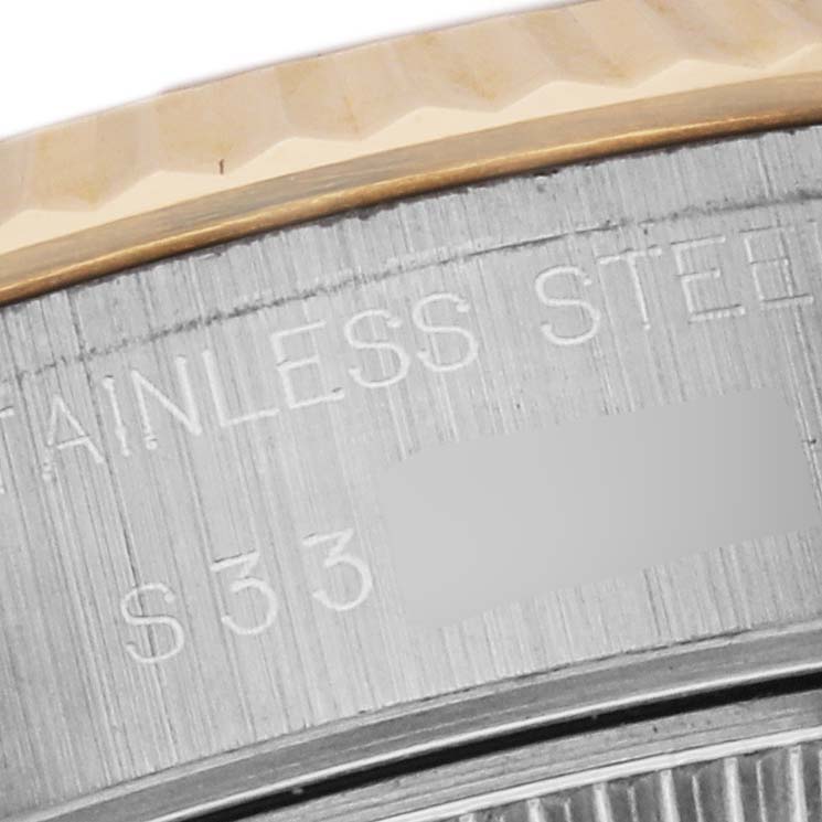 This close-up angle of the Rolex Datejust 79173 Women's Steel and Gold (two tone) Champagne Dial 79173 Women's Steel and Gold (two tone) Champagne Dial model shows part of the bezel and the engraved stainless steel case.