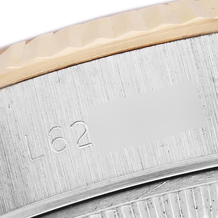 The image shows a close-up of the side of the Rolex Datejust 69173 Women
s Steel and Gold (two tone) Silver Dial 69173 Women
s Steel and Gold (two tone) Silver Dial bezel, highlighting the fluted edge and engraved details.