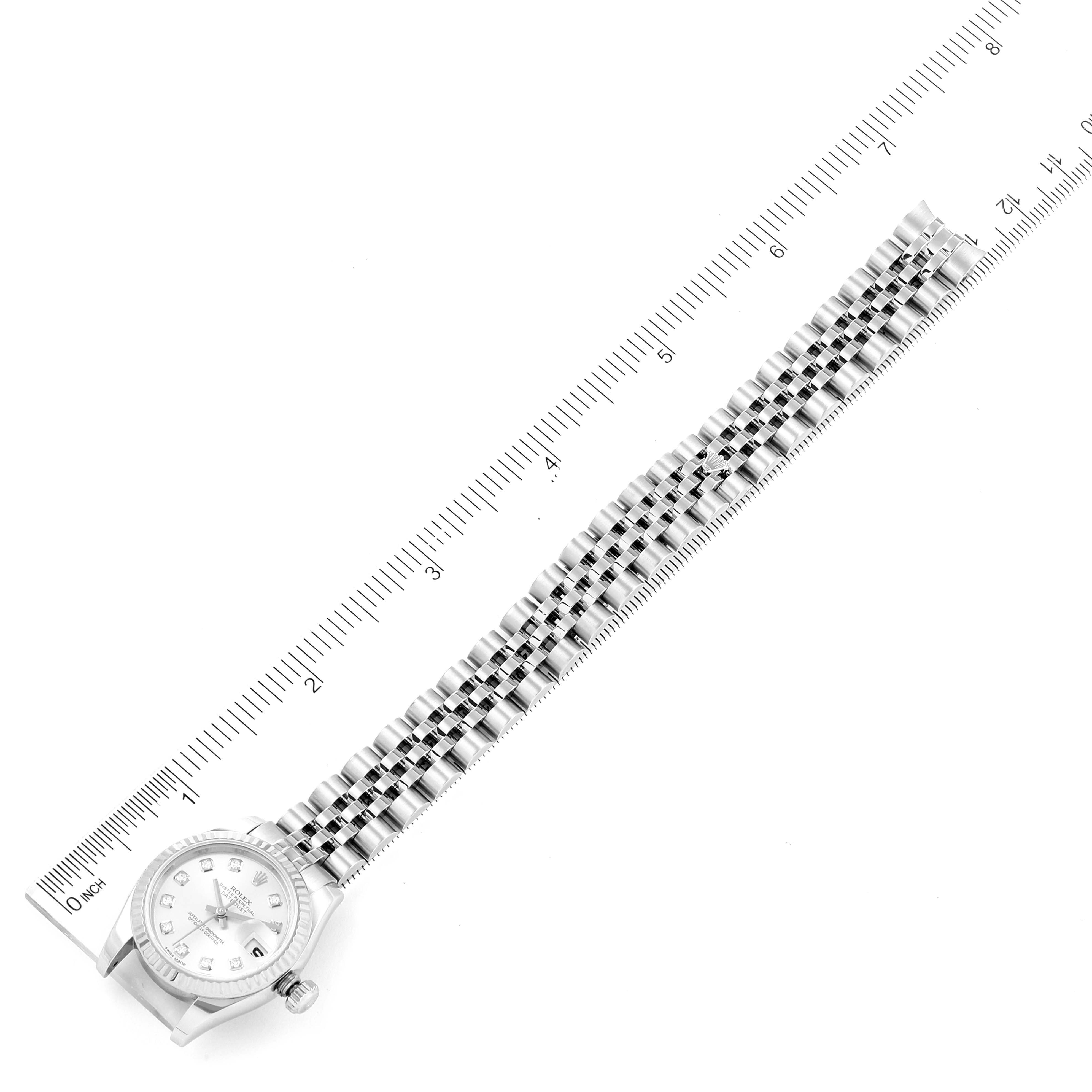 The image shows a Rolex Datejust 179174 Women's Stainless Steel Silver Dial 179174 Women's Stainless Steel Silver Dial watch from an overhead angle, highlighting the face, crown, and entire bracelet alongside a ruler.