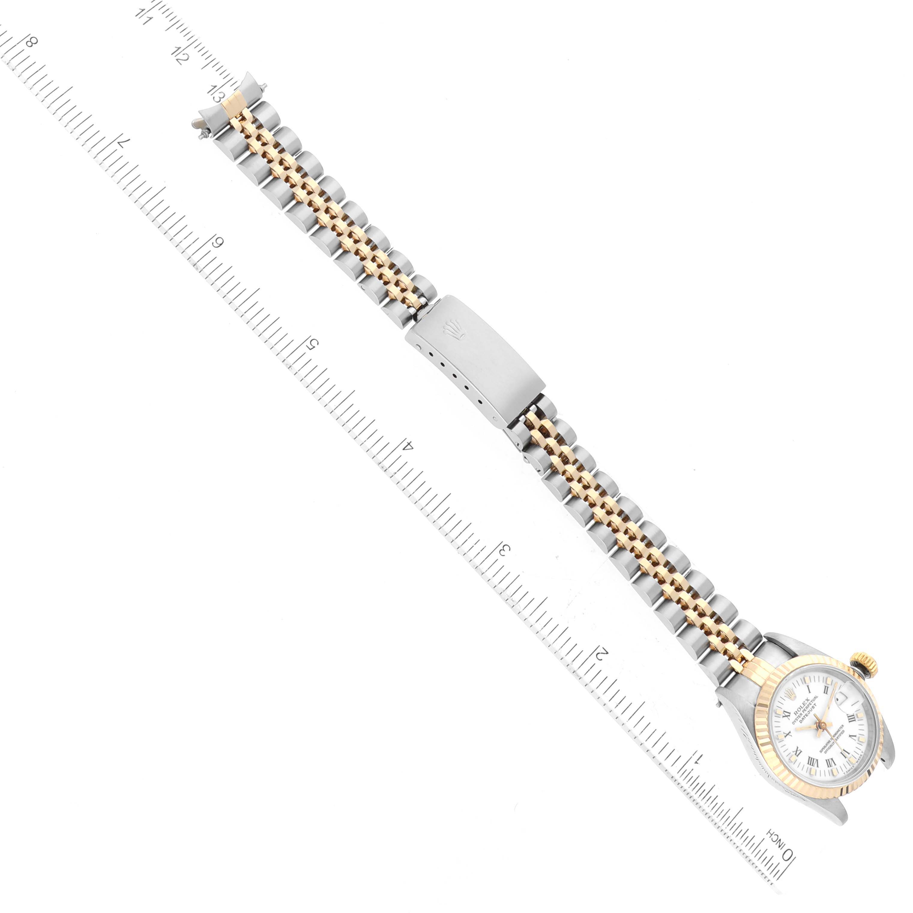 This image shows the Rolex Datejust 69173 Women's Steel and Gold (two tone) White Dial 69173 Women's Steel and Gold (two tone) White Dial watch laid out flat with a ruler, displaying the dial, bracelet, and clasp.