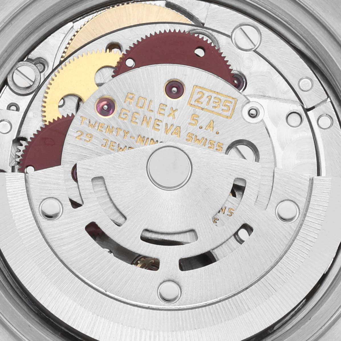 The image shows the inner movement mechanism of a Rolex Datejust 69173 Women's Steel and Gold (two tone) White Dial 69173 Women's Steel and Gold (two tone) White Dial watch, highlighting gears and engraved text.
