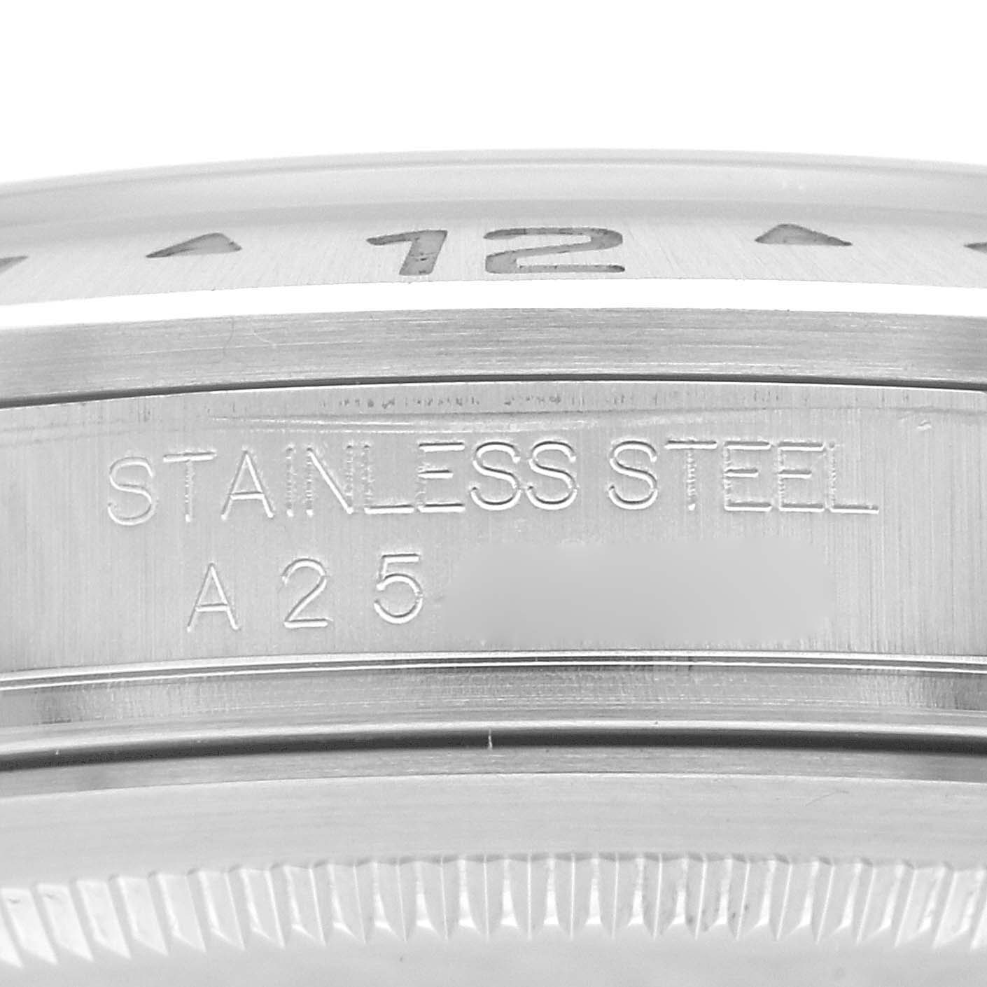 The image shows a close-up of the case side and bezel edge of a Rolex Explorer 16570 Men
s Stainless Steel White Dial 16570 Men
s Stainless Steel White Dial watch, with "STAINLESS STEEL" engraved.