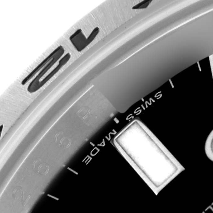 Close-up view of the Rolex Explorer 216570 Men
s Stainless Steel Black Dial 216570 Men
s Stainless Steel Black Dial watch showing part of the dial, bezel, and markers.