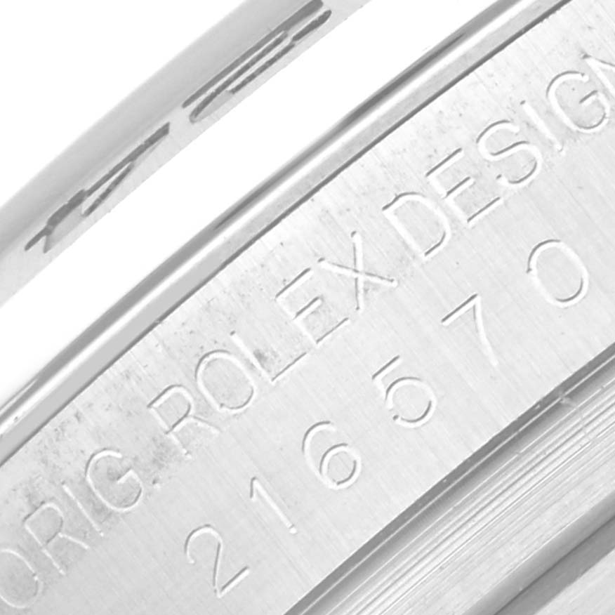 The image shows a close-up of the engraved case side of the Rolex Explorer 216570 Men
s Stainless Steel Black Dial 216570 Men
s Stainless Steel Black Dial model, displaying the serial and model numbers.