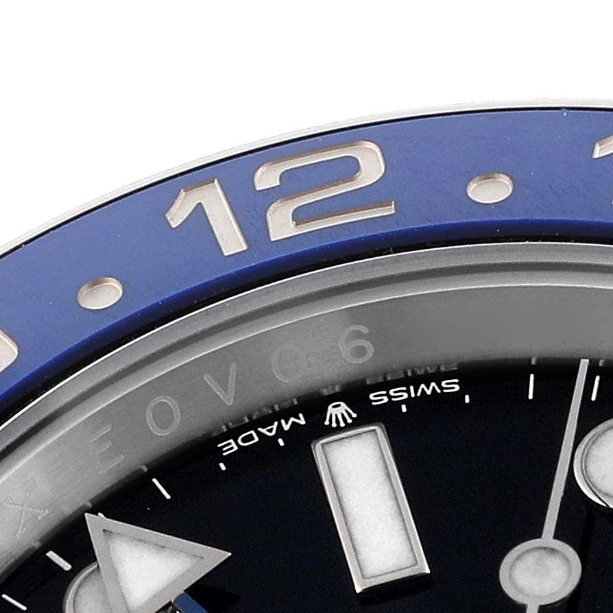 This close-up angle shows the bezel, part of the dial, and the hand of a Rolex GMT-Master 126710BLNR Men's Stainless Steel Black Dial 126710BLNR Men's Stainless Steel Black Dial watch.