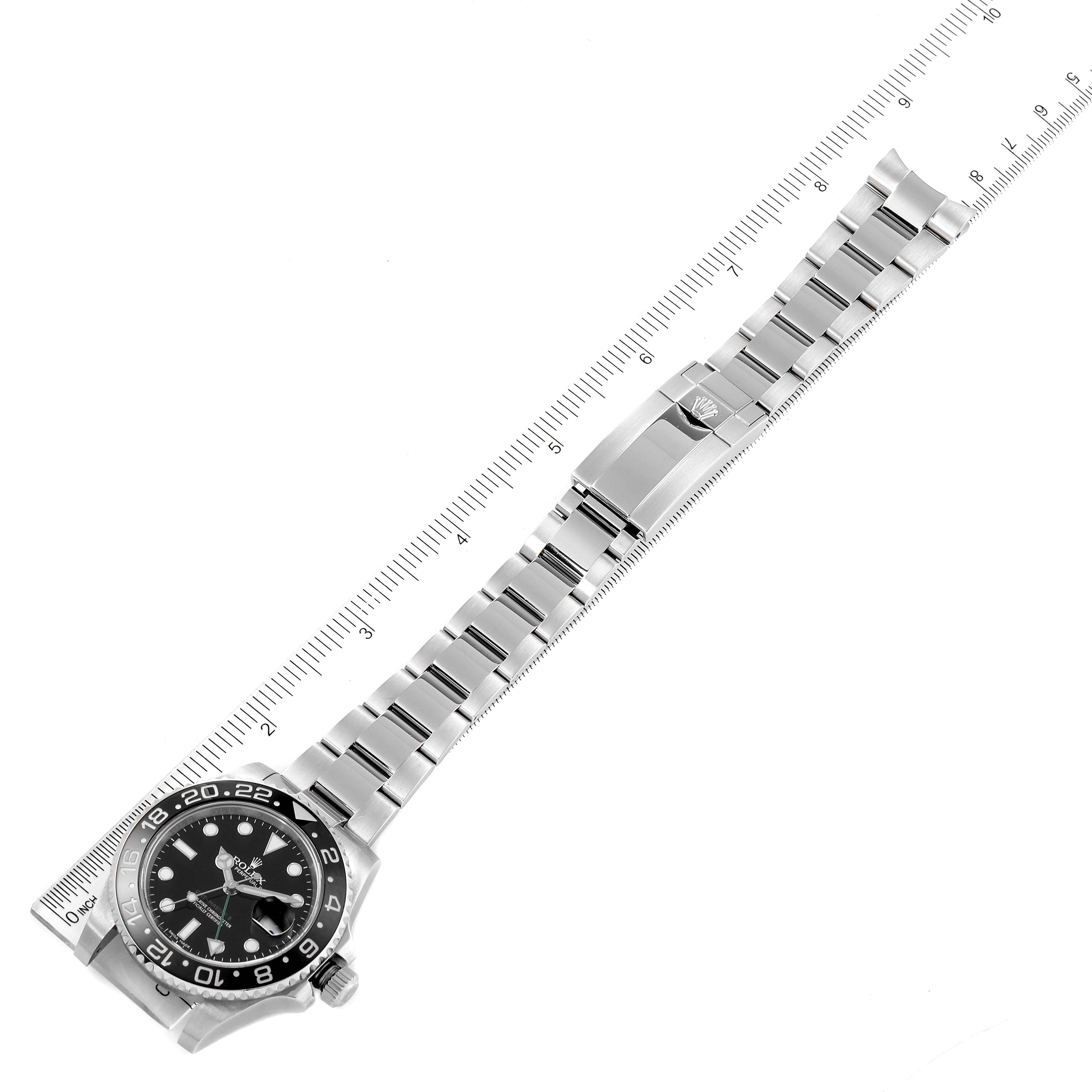 The Rolex GMT-Master 116710 Men's Stainless Steel Black Dial 116710 Men's Stainless Steel Black Dial watch is shown laid flat, with a view of the face, bezel, and full bracelet, alongside a measuring scale.