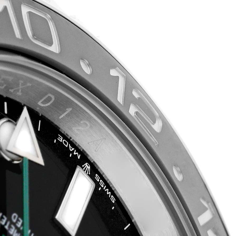 The image shows a close-up of the Rolex GMT-Master 126710 Men's Stainless Steel Black Dial's bezel, hour marker, and a portion of the dial.