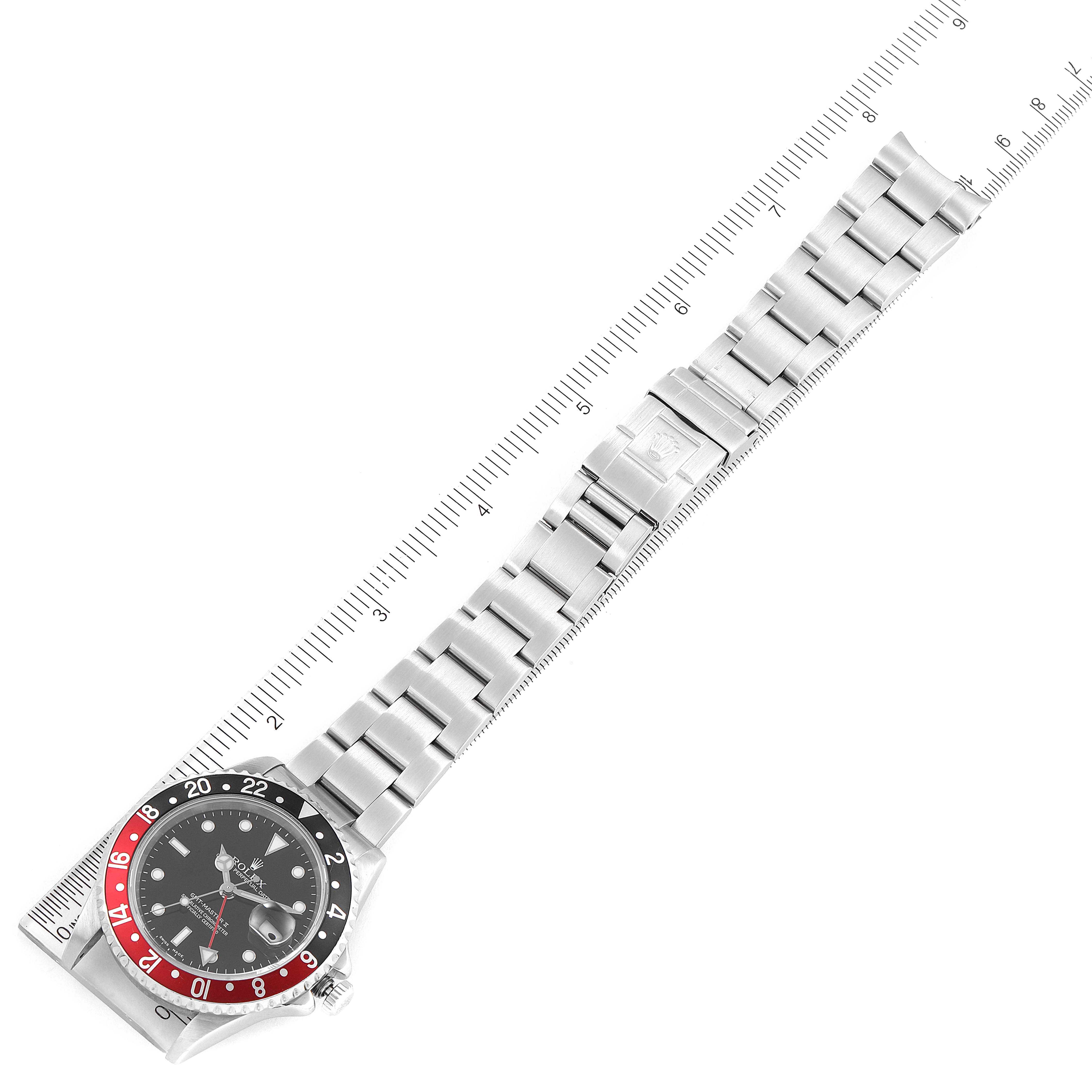 The image shows a Rolex GMT-Master 16710 Men's Stainless Steel Black Dial 16710 Men's Stainless Steel Black Dial watch laid flat, face up, with a ruler for scale.