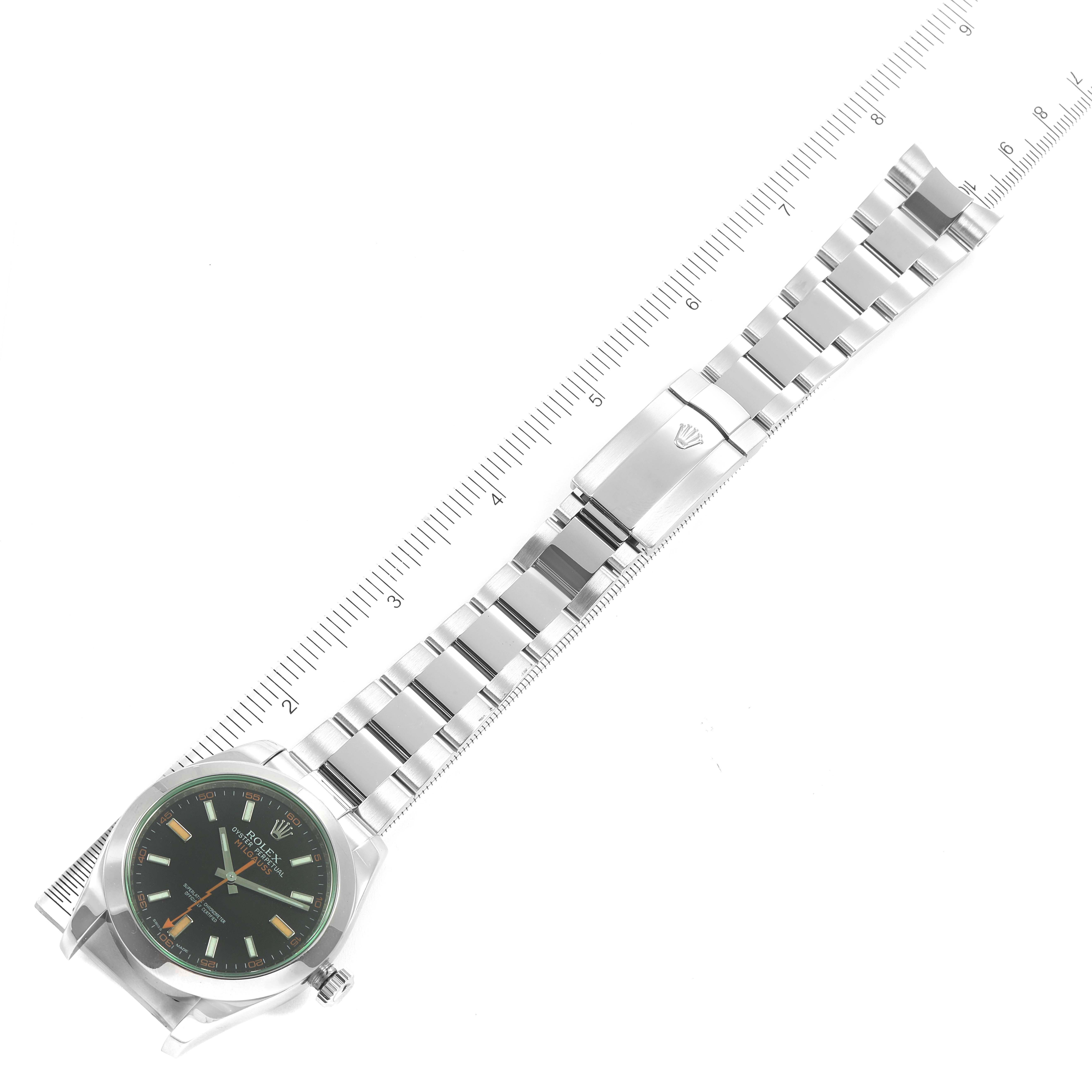 The image shows a top-down view of a Rolex Milgauss 116400GV Men's Stainless Steel Black Dial 116400GV Men's Stainless Steel Black Dial watch, including its face, bracelet, and clasp, with a ruler for scale.