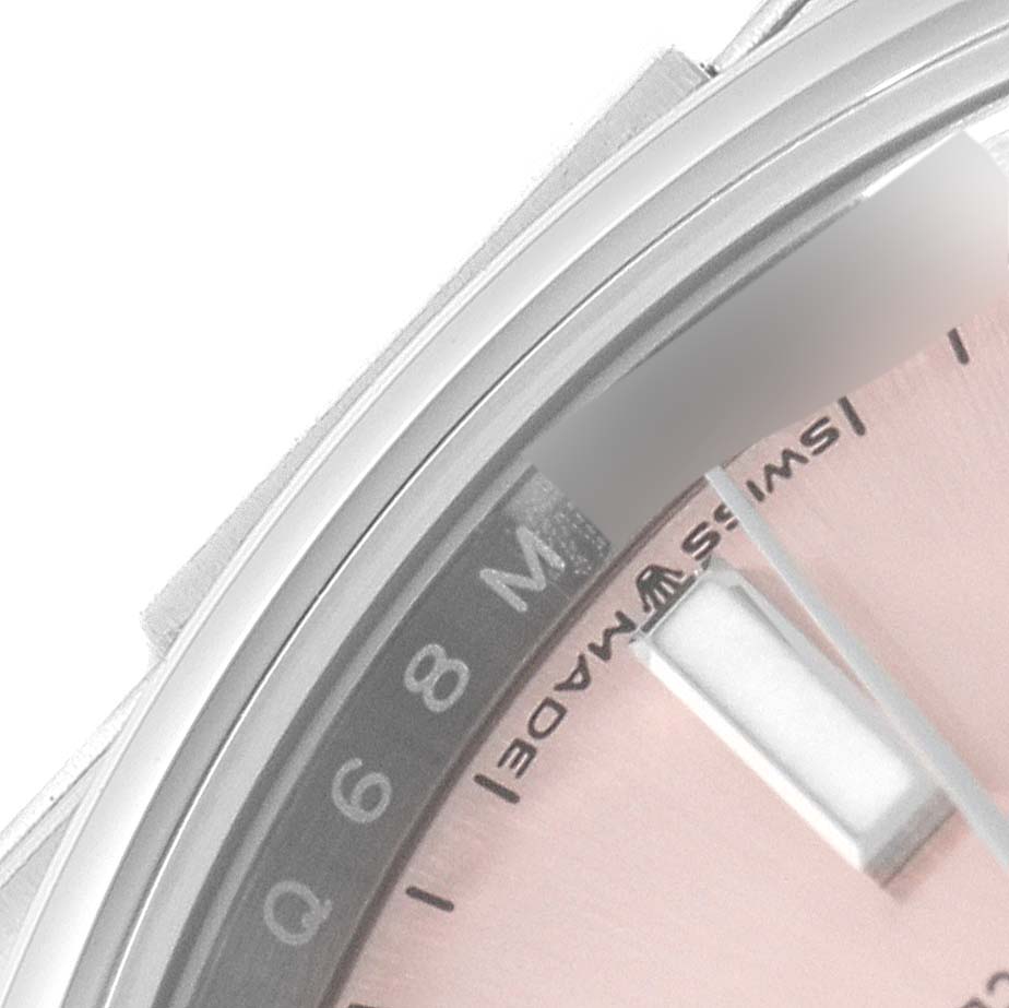 This image shows a close-up angle of the dial, bezel, and minute markers on a Rolex Oyster Perpetual 124200 Men's Stainless Steel Pink Dial 124200 Men's Stainless Steel Pink Dial watch.