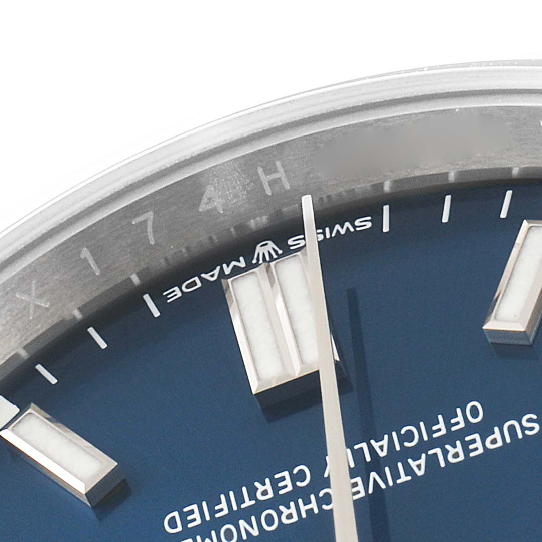 This close-up angle shows the dial, hour markers, and part of the bezel of the Rolex Oyster Perpetual 126000 Men's Stainless Steel Blue Dial 126000 Men's Stainless Steel Blue Dial watch.