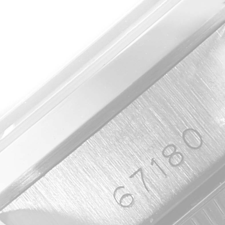 The image shows a close-up of the side engraving on the case of a Rolex Oyster Perpetual 67180 Women's Stainless Steel Pink Dial 67180 Women's Stainless Steel Pink Dial watch, displaying the model number "67180."