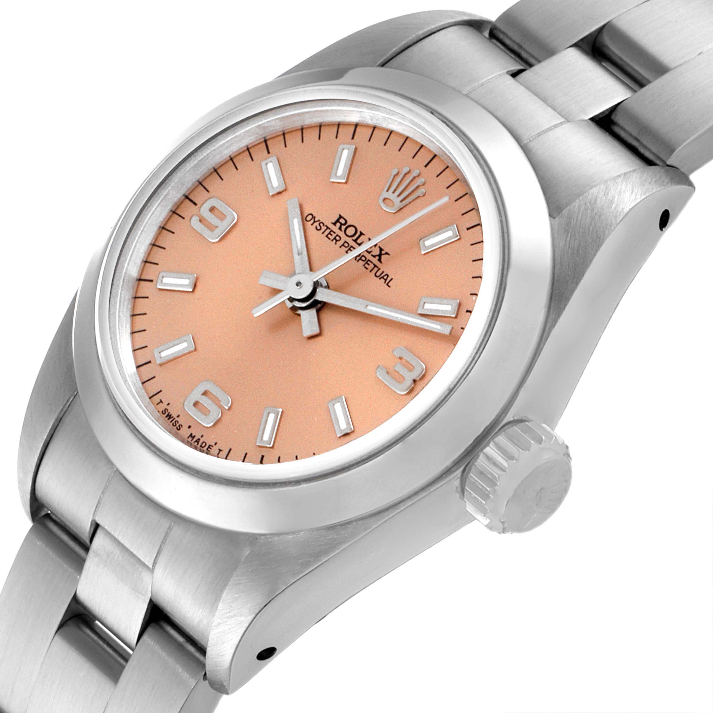 The image shows the dial, crown, and bracelet of a Rolex Oyster Perpetual 67180 Women's Stainless Steel Pink Dial 67180 Women's Stainless Steel Pink Dial watch from a slight oblique angle.