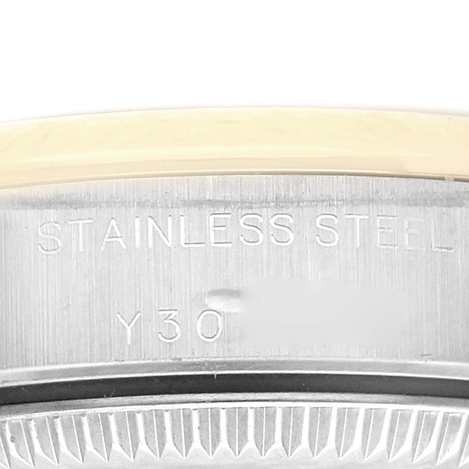 The image shows a close-up of the case back engraving on a Rolex Oyster Perpetual 76183 Women
s Steel and Gold (two tone) White Dial 76183 Women
s Steel and Gold (two tone) White Dial watch, highlighting the steel material.