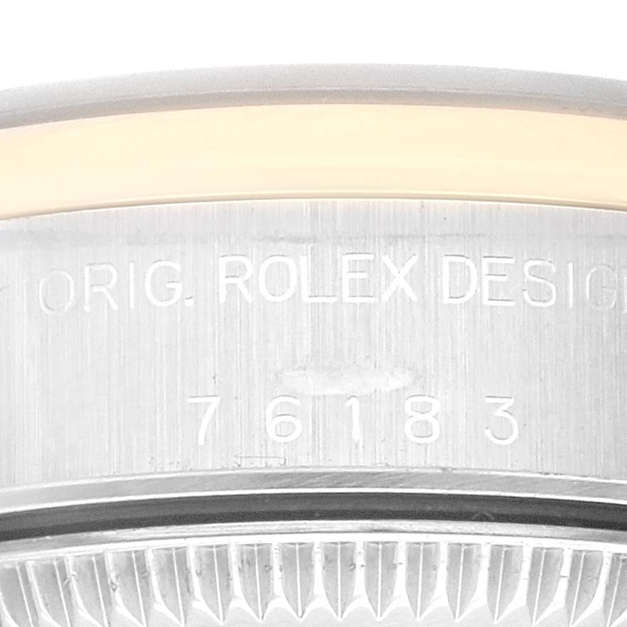 This image shows a close-up of the case back of a Rolex Oyster Perpetual 76183 Women
s Steel and Gold (two tone) White Dial 76183 Women
s Steel and Gold (two tone) White Dial watch, revealing the model number and "ORIG. ROLEX DESIGN" engraving.