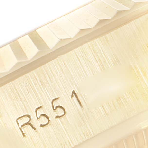 This close-up image shows the fluted bezel and partial engravings on a Rolex Datejust 69178 Women's Yellow Gold Champagne Dial 69178 Women's Yellow Gold Champagne Dial watch.
