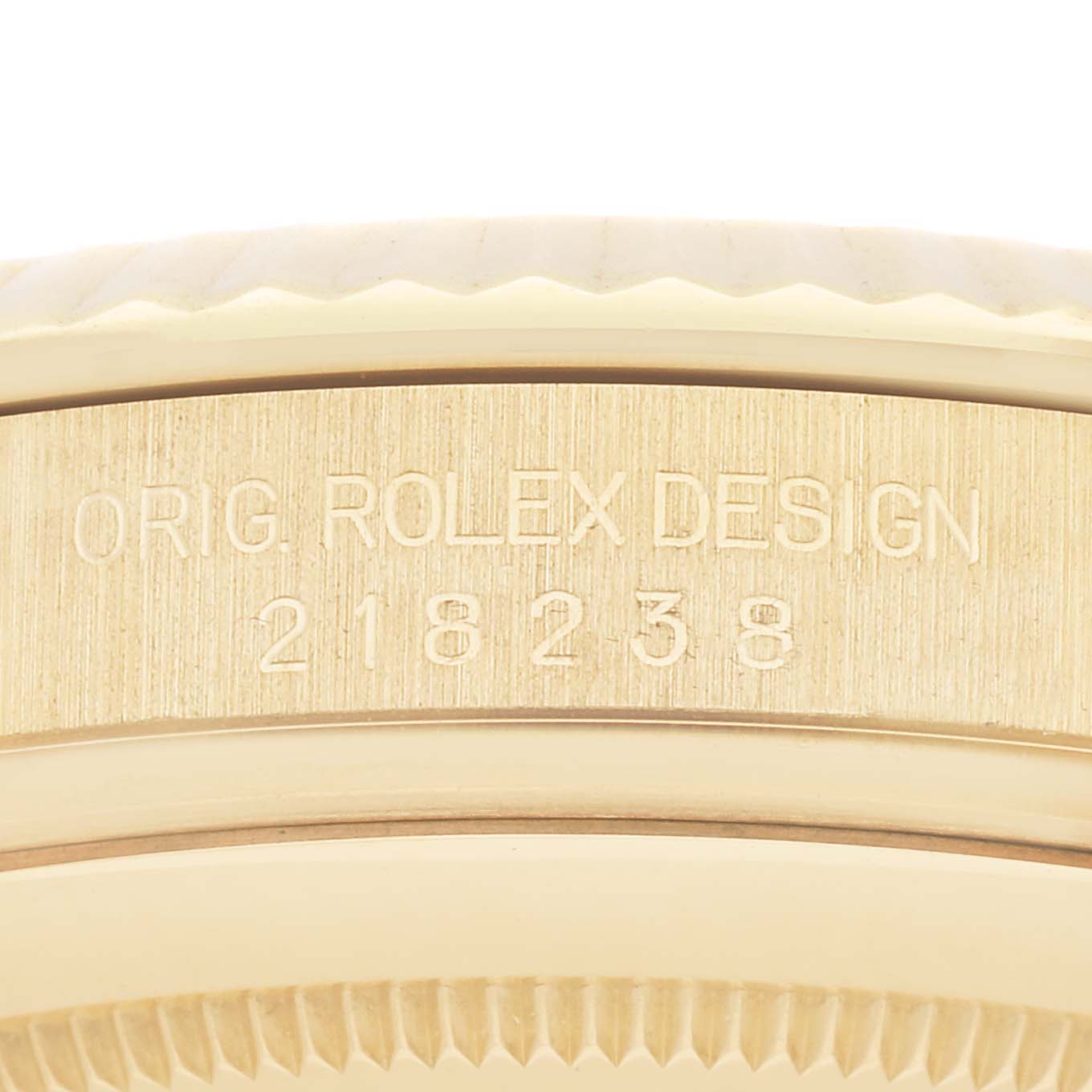 The image shows a close-up view of the side of a Rolex President 218238 Men
s Yellow Gold Champagne Dial 218238 Men
s Yellow Gold Champagne Dial watch, focusing on the model number engraving.