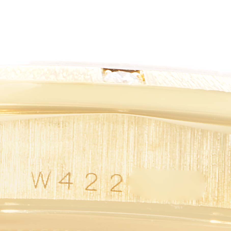 The image shows a close-up of the side of a Rolex President 18308 Men
s Yellow Gold White Dial 18308 Men
s Yellow Gold White Dial watch, highlighting part of the case and a serial number.