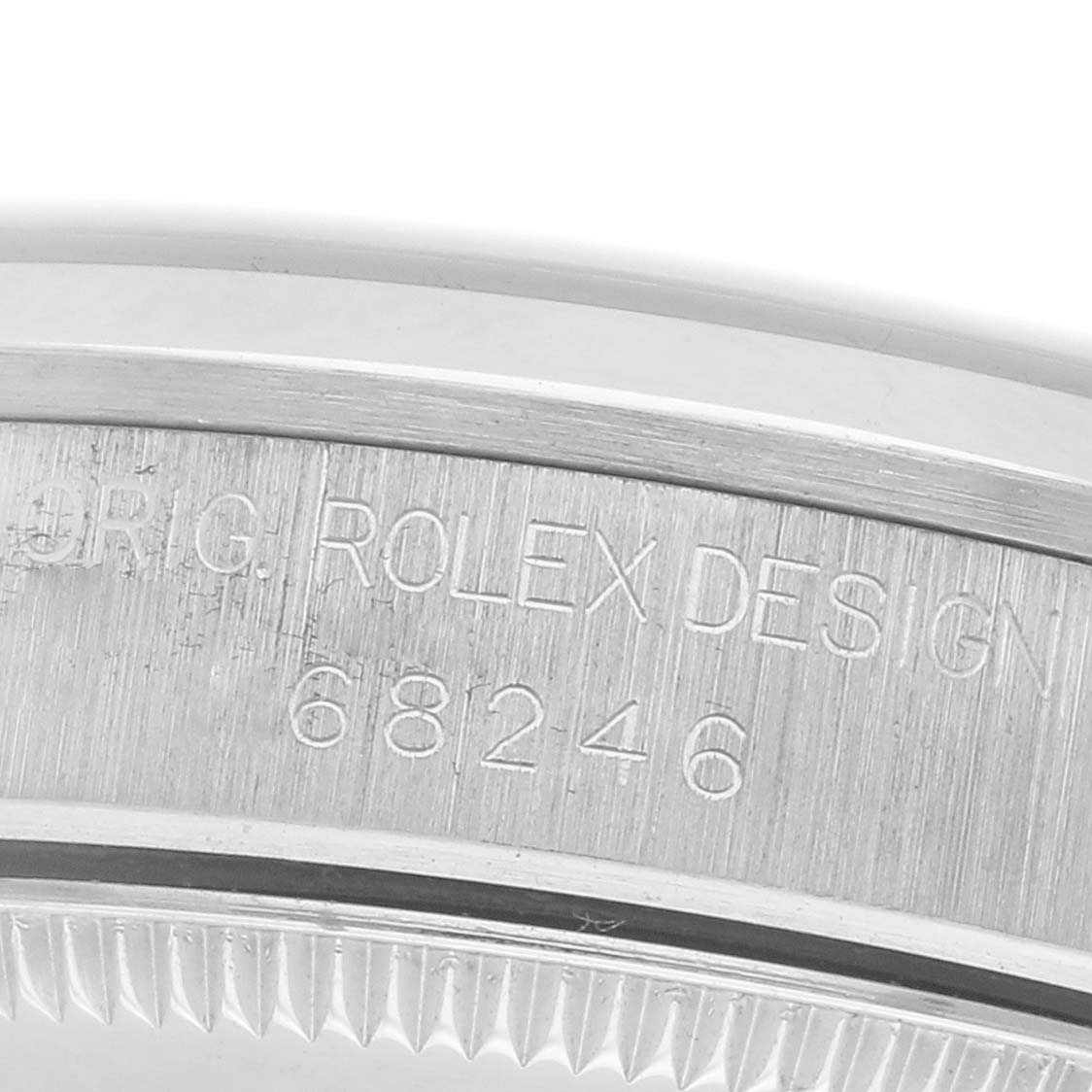 The image shows a close-up of the side engraving on a Rolex Mid-Size 68246 Women
s Platinum Silver Dial 68246 Women
s Platinum Silver Dial model, showcasing the model number "68246."