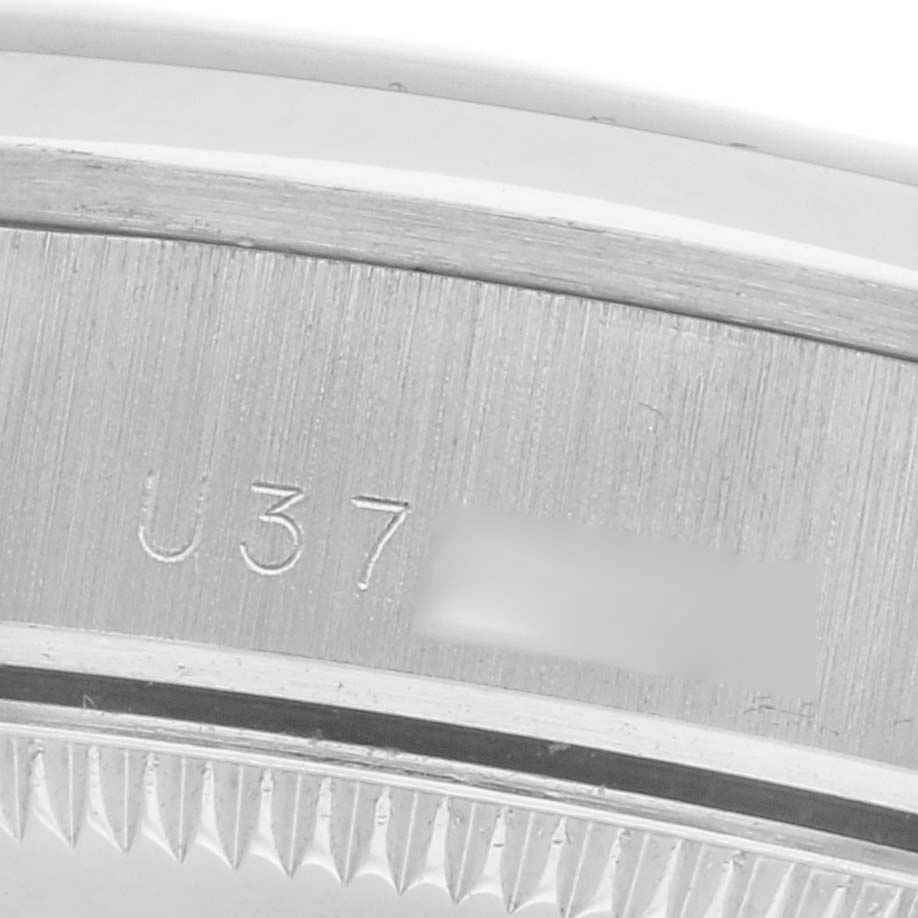 The image shows a close-up of the case back edge of a Rolex Mid-Size 68246 Women
s Platinum Silver Dial 68246 Women
s Platinum Silver Dial model with visible engravings.