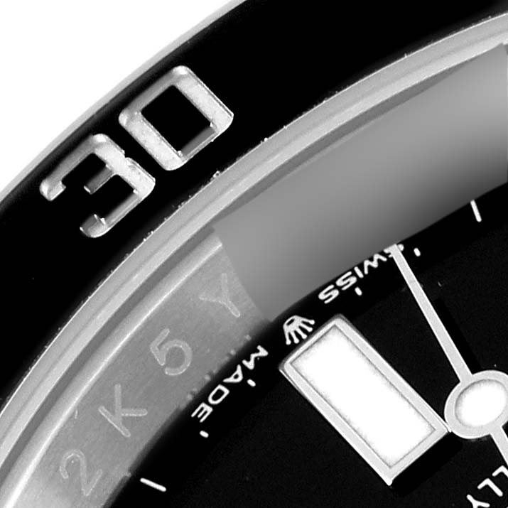 This image shows a close-up of the bezel and a portion of the dial of a Rolex Submariner 126610LN Men
s Stainless Steel Black Dial 126610LN Men
s Stainless Steel Black Dial watch.