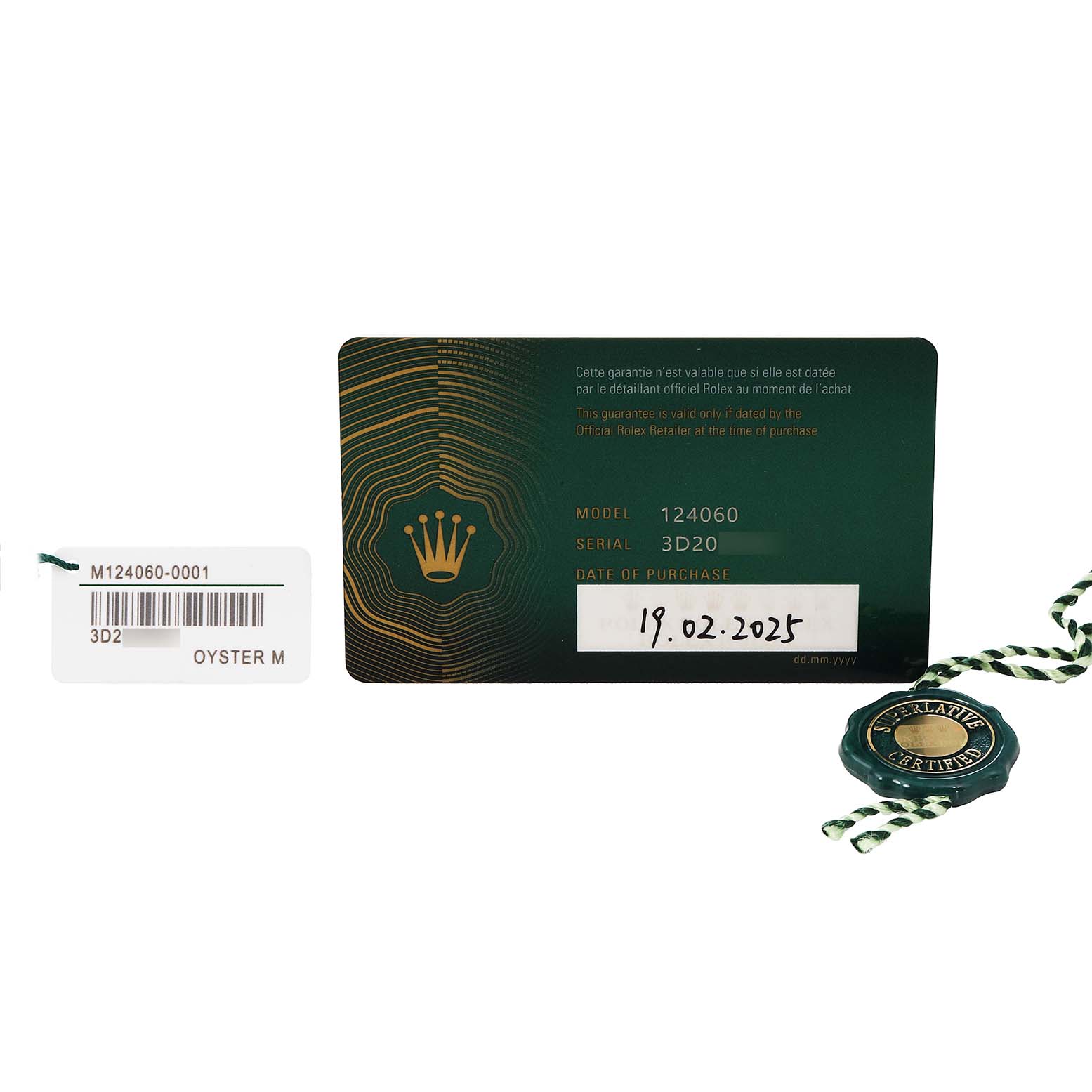 The image shows a Rolex Submariner 124060 Men's Stainless Steel Black Dial warranty card and tag accessories from a top angle.