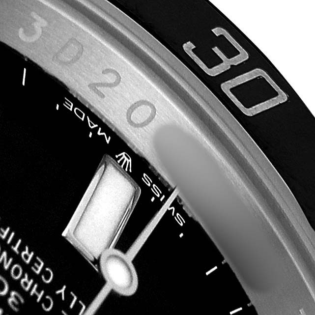 This close-up of the Rolex Submariner 124060 Men's Stainless Steel Black Dial shows part of the bezel, a date window, and markings on the watch face.