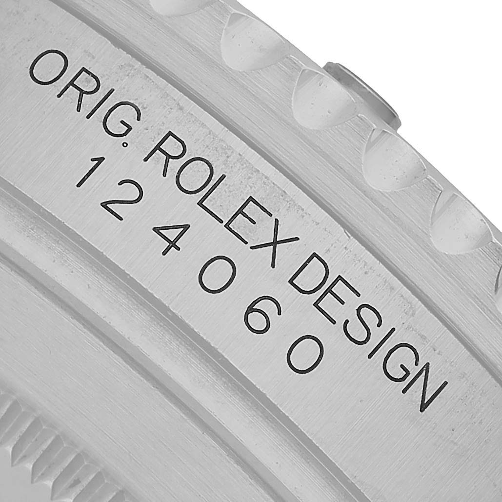 The image shows a close-up of the Rolex Submariner 124060 Men's Stainless Steel Black Dial's case side, featuring the engraved model number "124060" and "ORIG. ROLEX DESIGN."