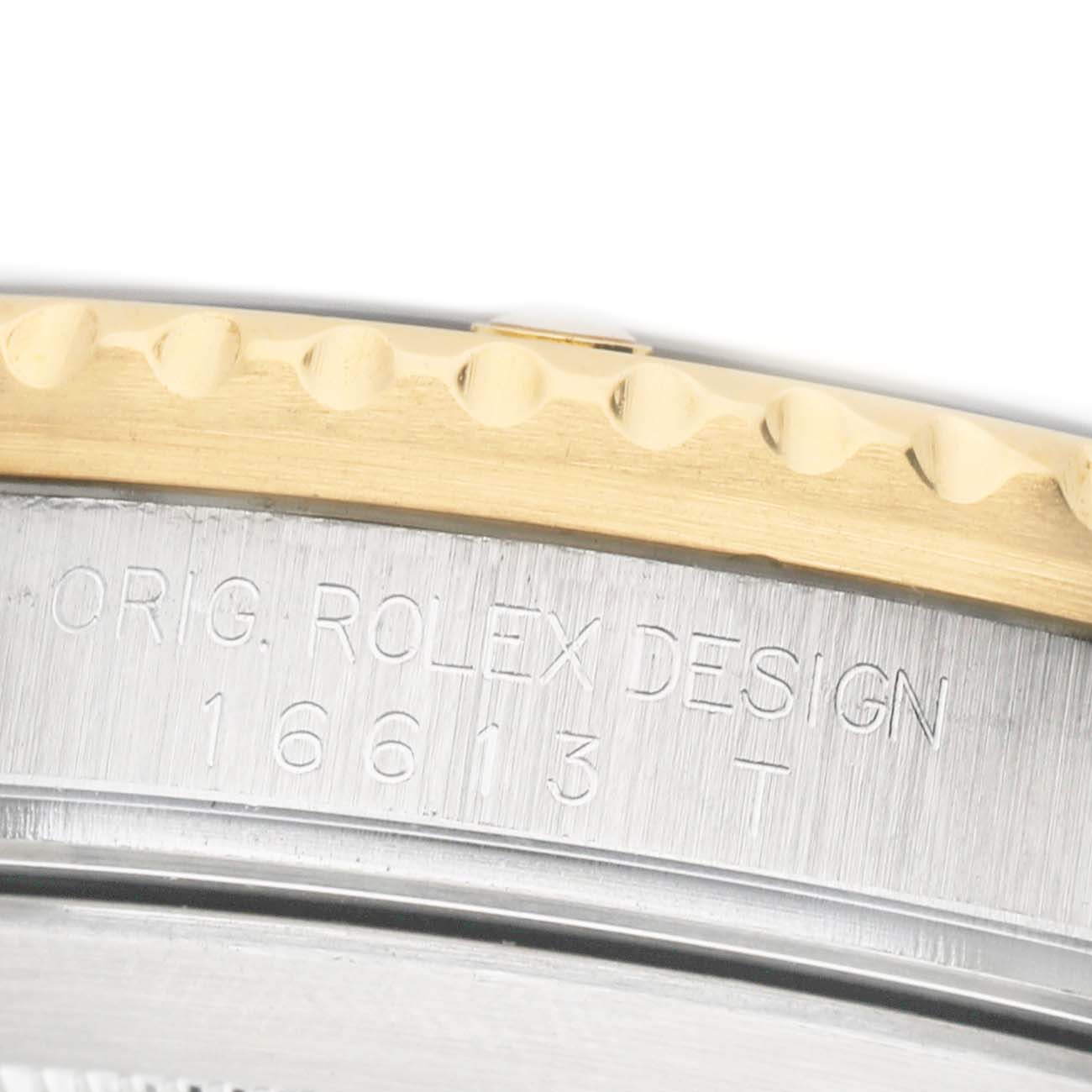 The image shows a close-up of the Rolex Submariner 16613 Men's Steel and Gold (two tone) Blue Dial's case side, highlighting the model engraving (16613) and part of the bezel.