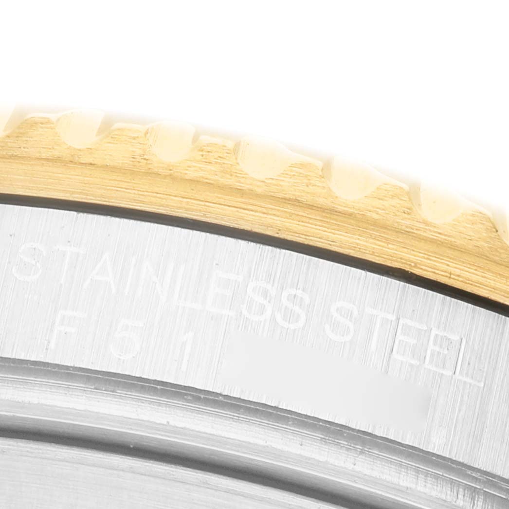 The image shows a close-up of the Rolex Submariner 16613 Men's Steel and Gold (two tone) Blue Dial bezel and outer rim with "STAINLESS STEEL" engraving visible.