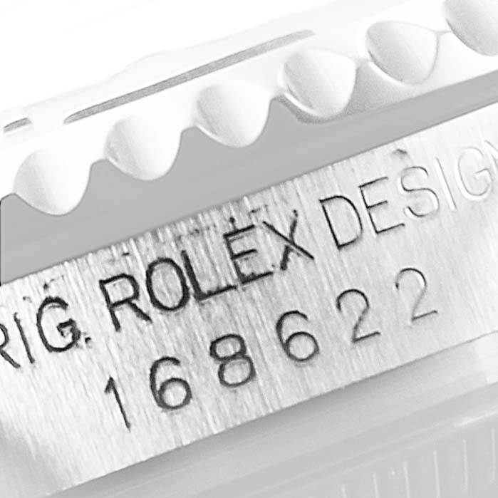 The image shows a close-up of the case side of a Rolex Yacht-Master 168622 Men
s Stainless Steel Silver Dial 168622 Men
s Stainless Steel Silver Dial watch, highlighting the serial number and "ROLEX DESIGN" engraving.