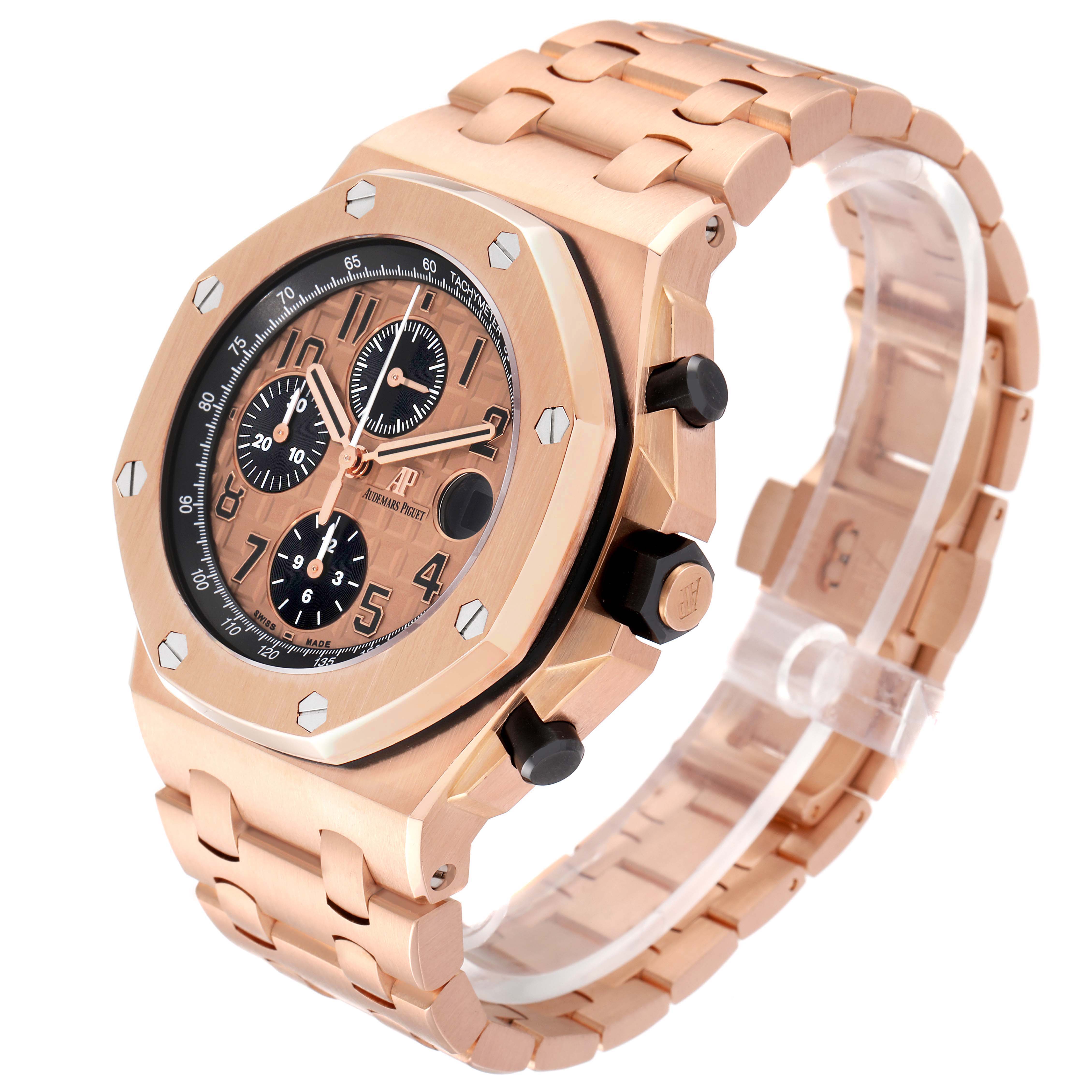 The Audemars Piguet Royal Oak Offshore 26470OR.OO.1000OR.01 Men's Rose Gold Pink Dial watch is shown at an angle displaying the front, side with pushers, and bracelet detail.