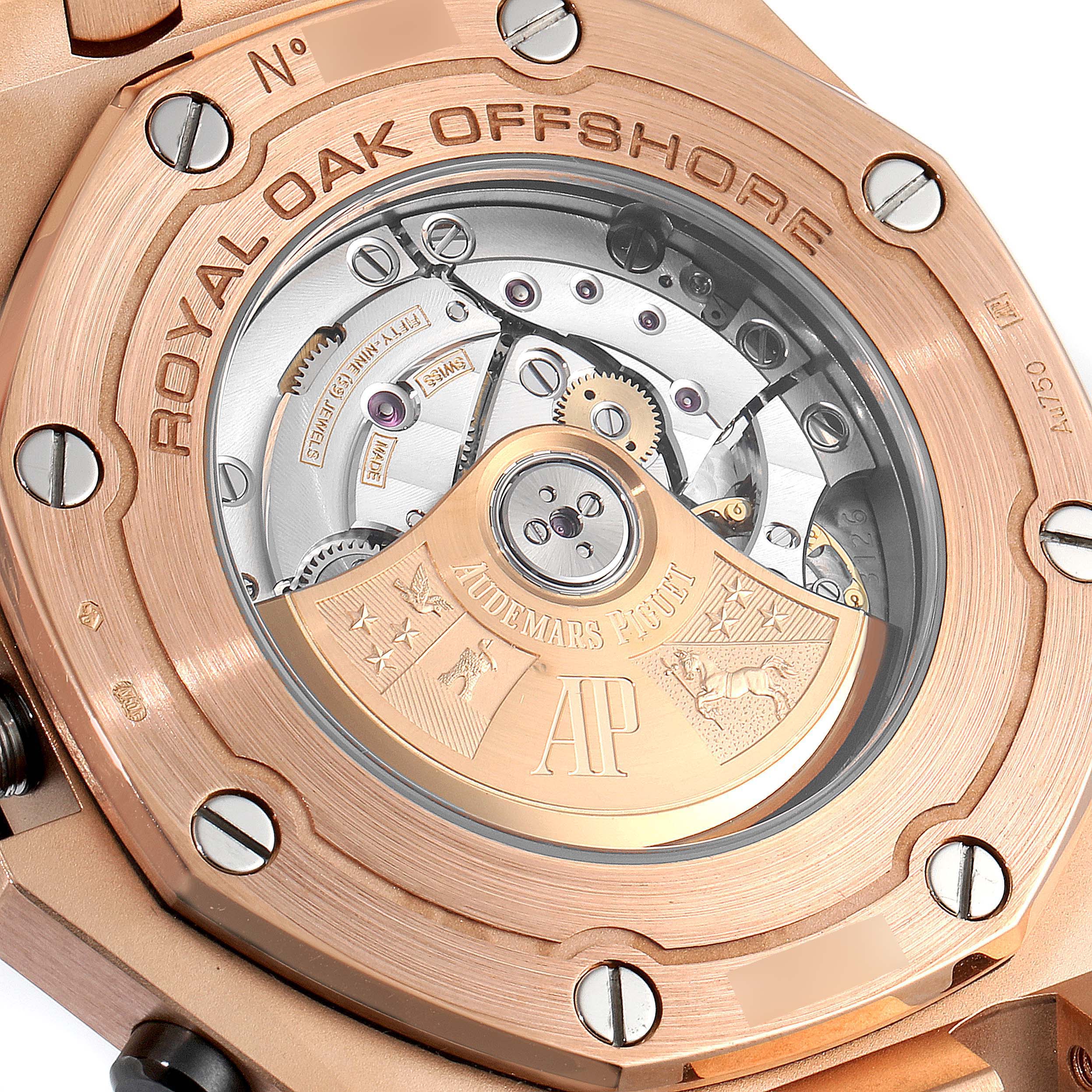This image shows the back view of an Audemars Piguet Royal Oak Offshore 26470OR.OO.1000OR.01 Men's Rose Gold Pink Dial 26470OR.OO.1000OR.01 Men's Rose Gold Pink Dial watch, revealing its intricate movement and branding.