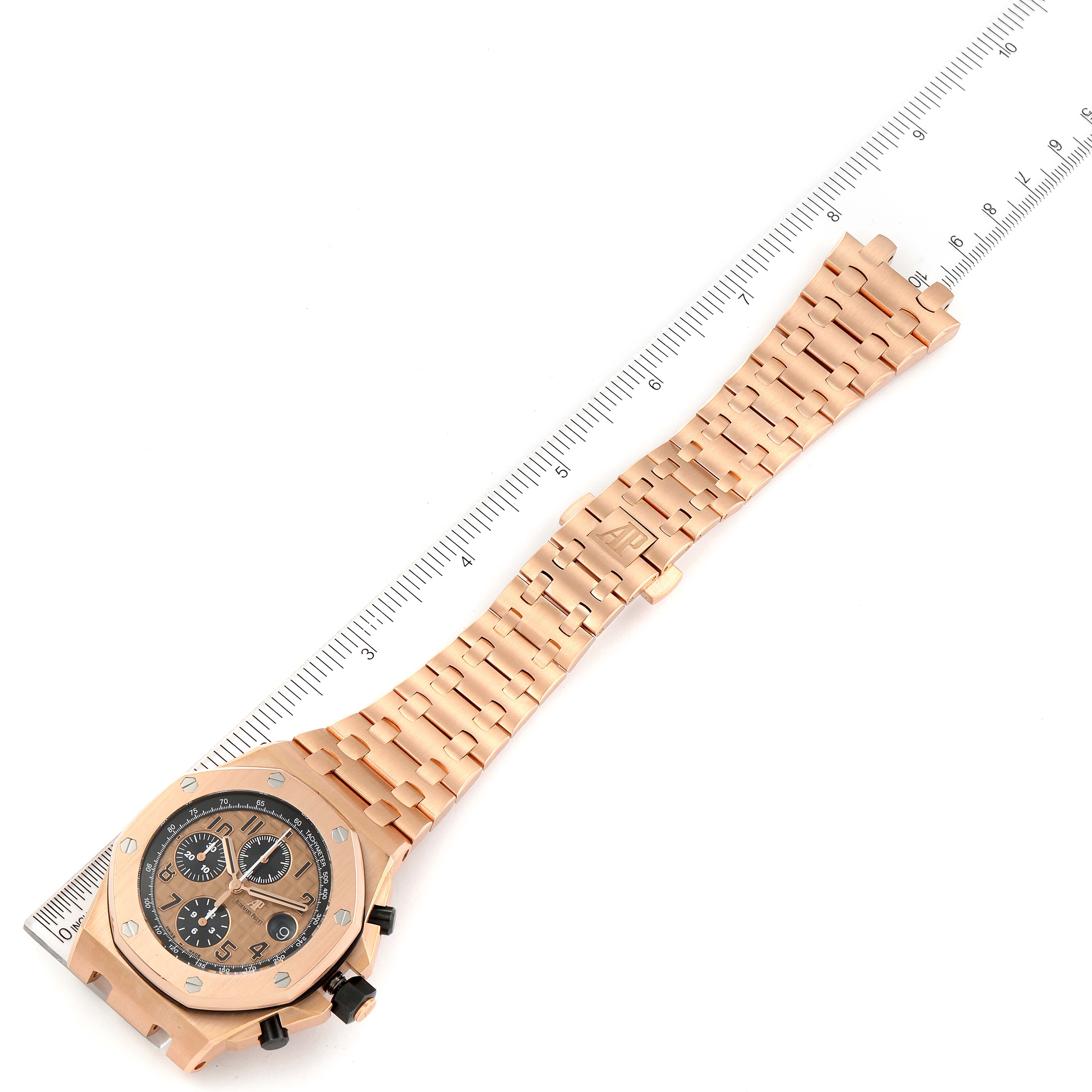 This image shows an Audemars Piguet Royal Oak Offshore 26470OR.OO.1000OR.01 Men's Rose Gold Pink Dial 26470OR.OO.1000OR.01 Men's Rose Gold Pink Dial watch from a top-down angle with its case, dial, and bracelet visible.