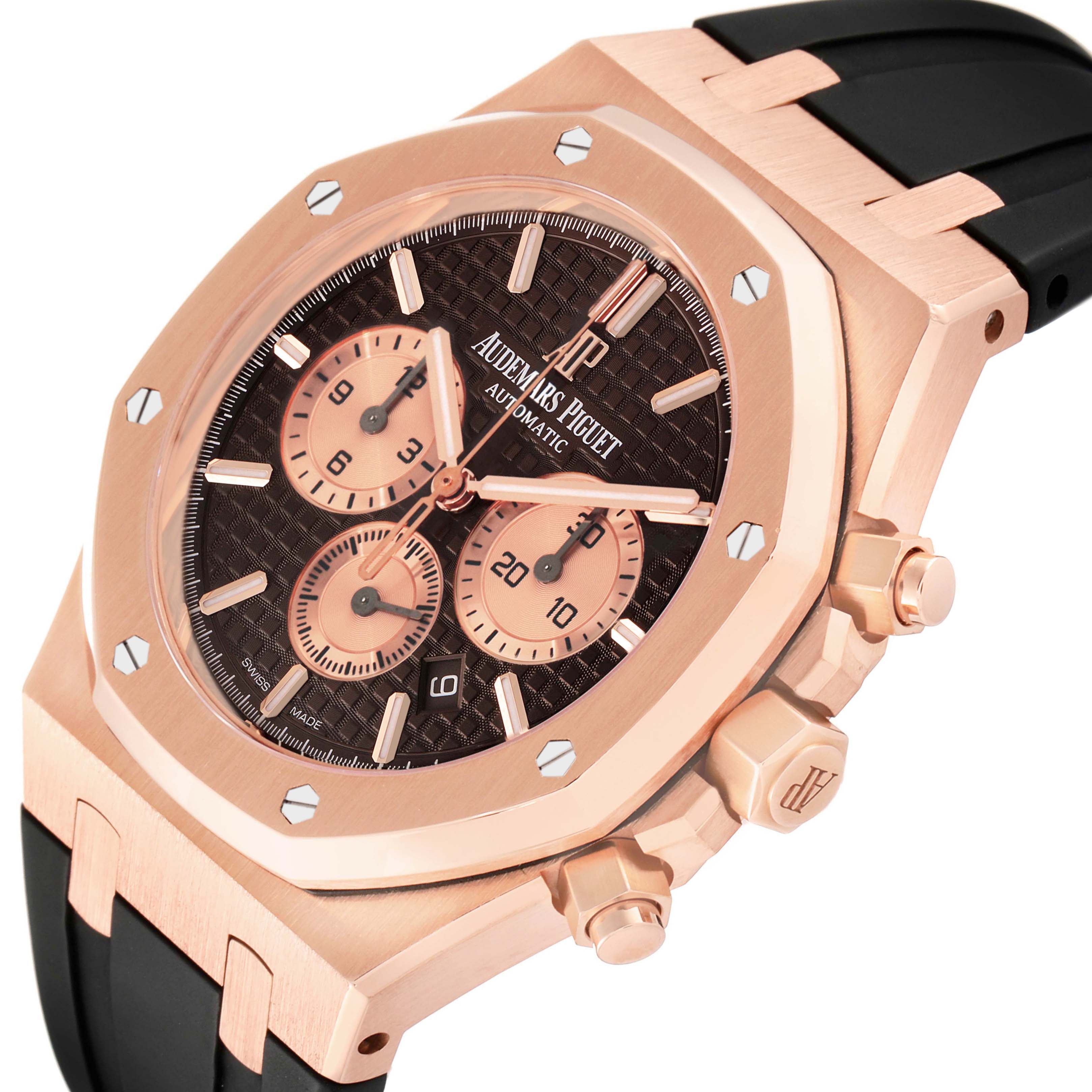 The image shows a close-up angle of an Audemars Piguet Royal Oak 26331OR.OO.D821CR.01 Men's Rose Gold Brown Dial 26331OR.OO.D821CR.01 Men's Rose Gold Brown Dial watch, highlighting its rose gold case, black strap, and chronograph dials.