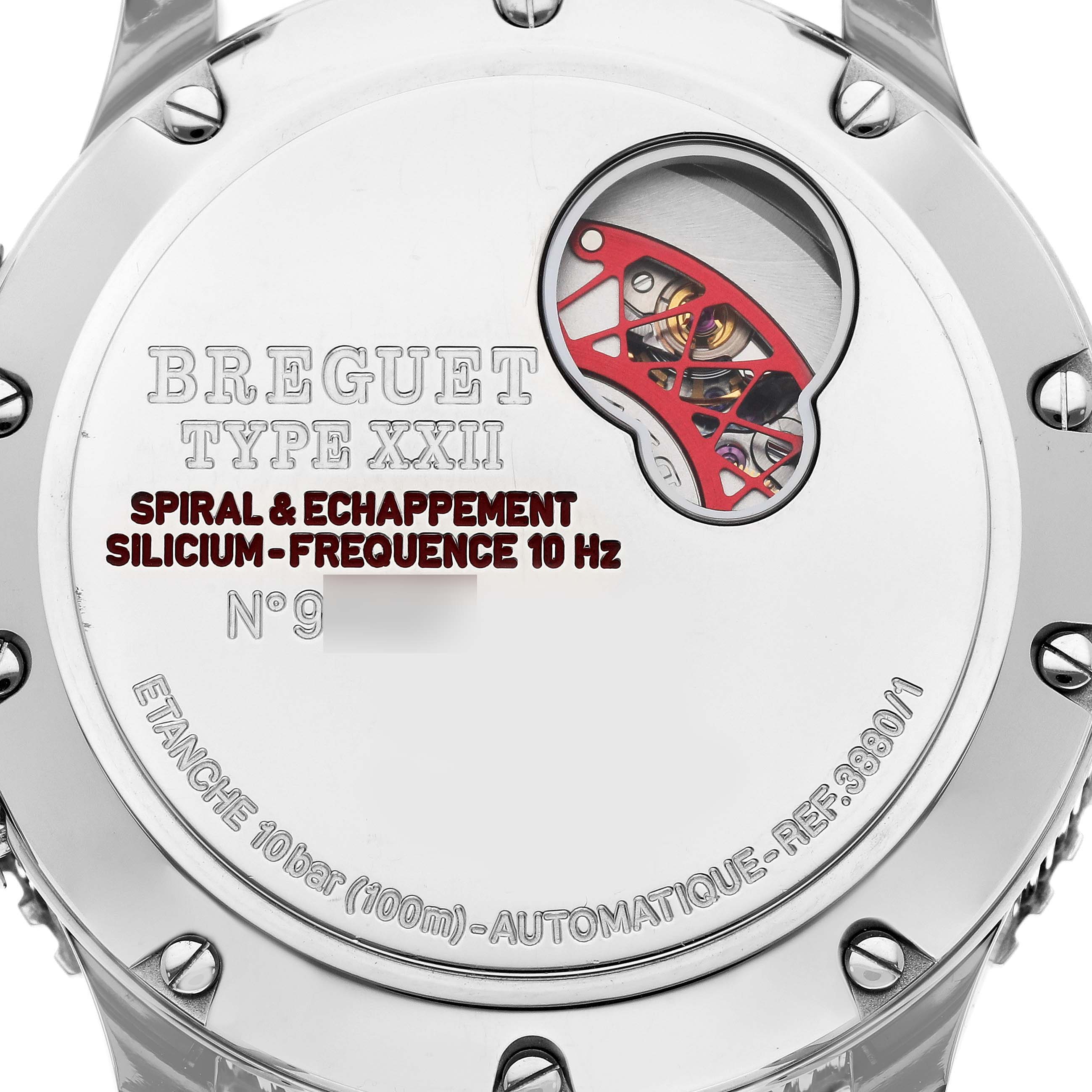 The image shows the back case of the Breguet Type XXII watch, highlighting the movement and specific technical inscriptions.