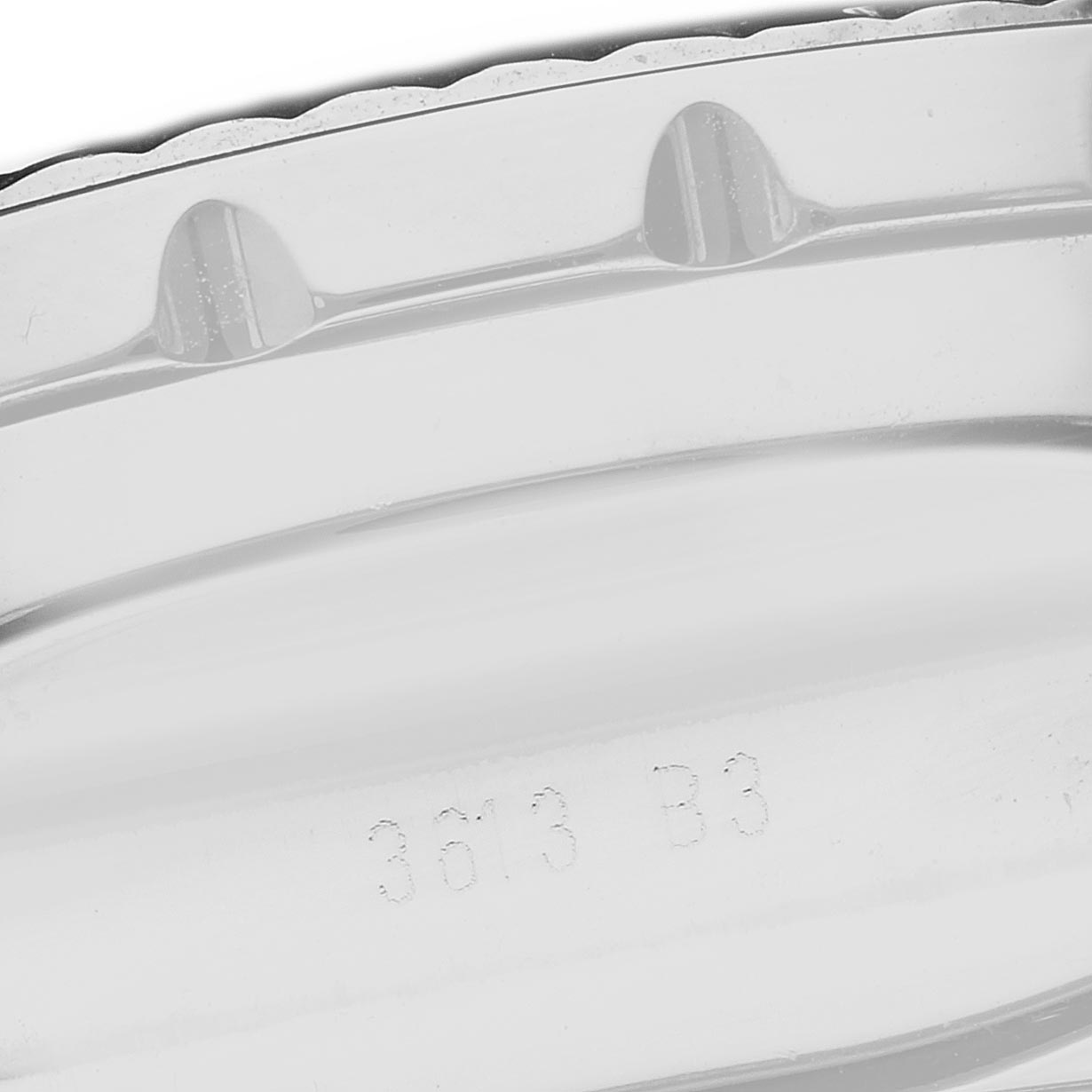 The image shows a close-up of the side view of a Breitling Bentley AB0431 Men
s Stainless Steel Black Dial AB0431 Men
s Stainless Steel Black Dial watch case, highlighting its metal texture and engraved markings.