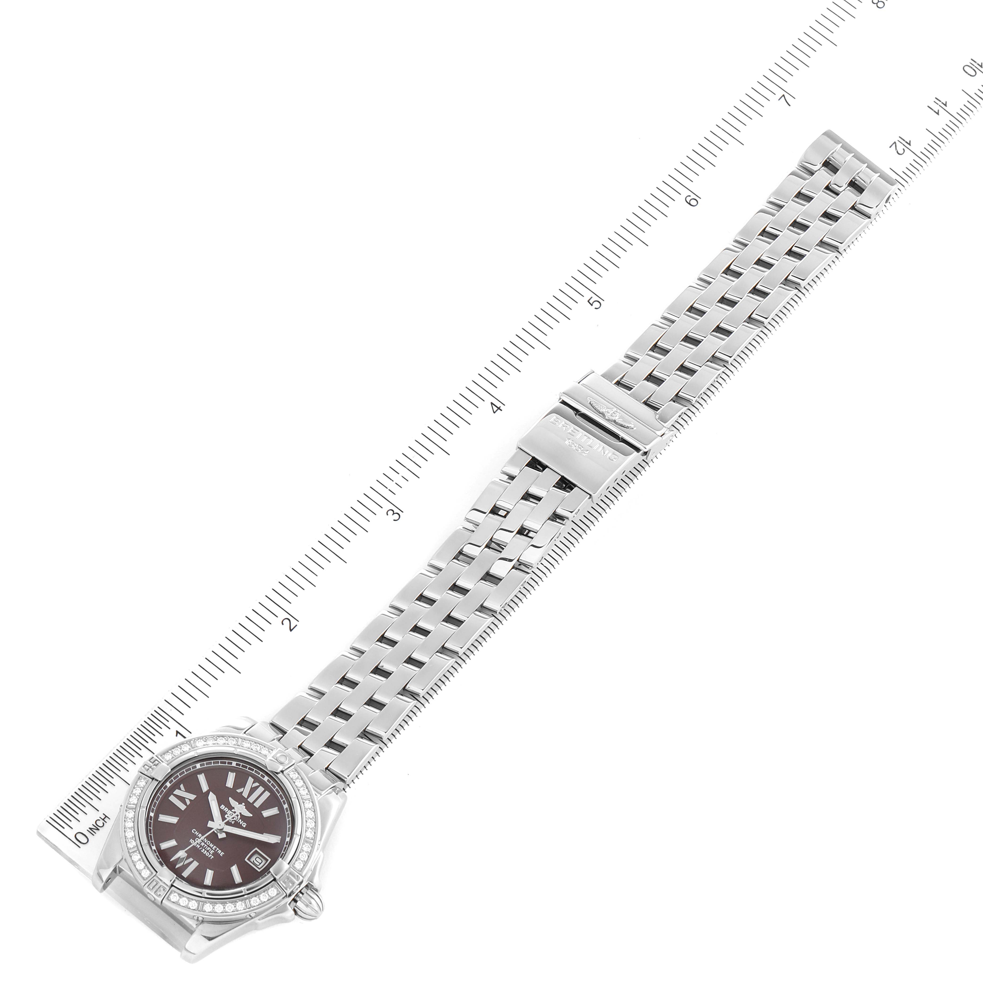 The Breitling A17356 Women's Stainless Steel Burgundy Dial A17356 Women's Stainless Steel Burgundy Dial Cockpit Chronometer A17356 is shown from an overhead angle, displaying the burgundy dial, diamond bezel, and metallic strap.