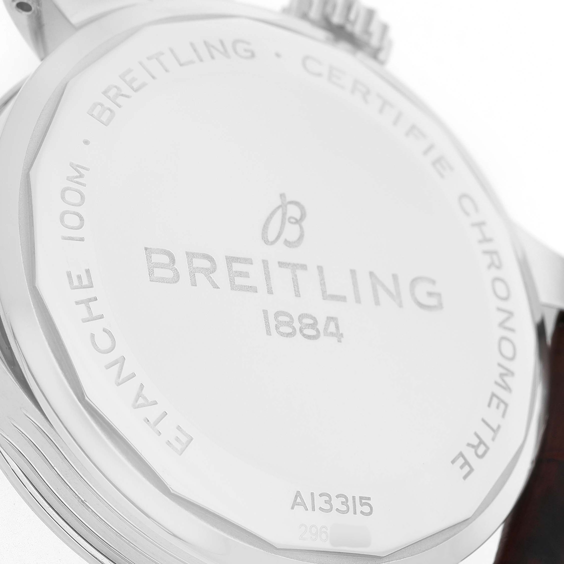 The image shows the case back of a Breitling Premier A13315 Men's Stainless Steel Blue Dial watch from a close, angled view, highlighting branding and engravings.