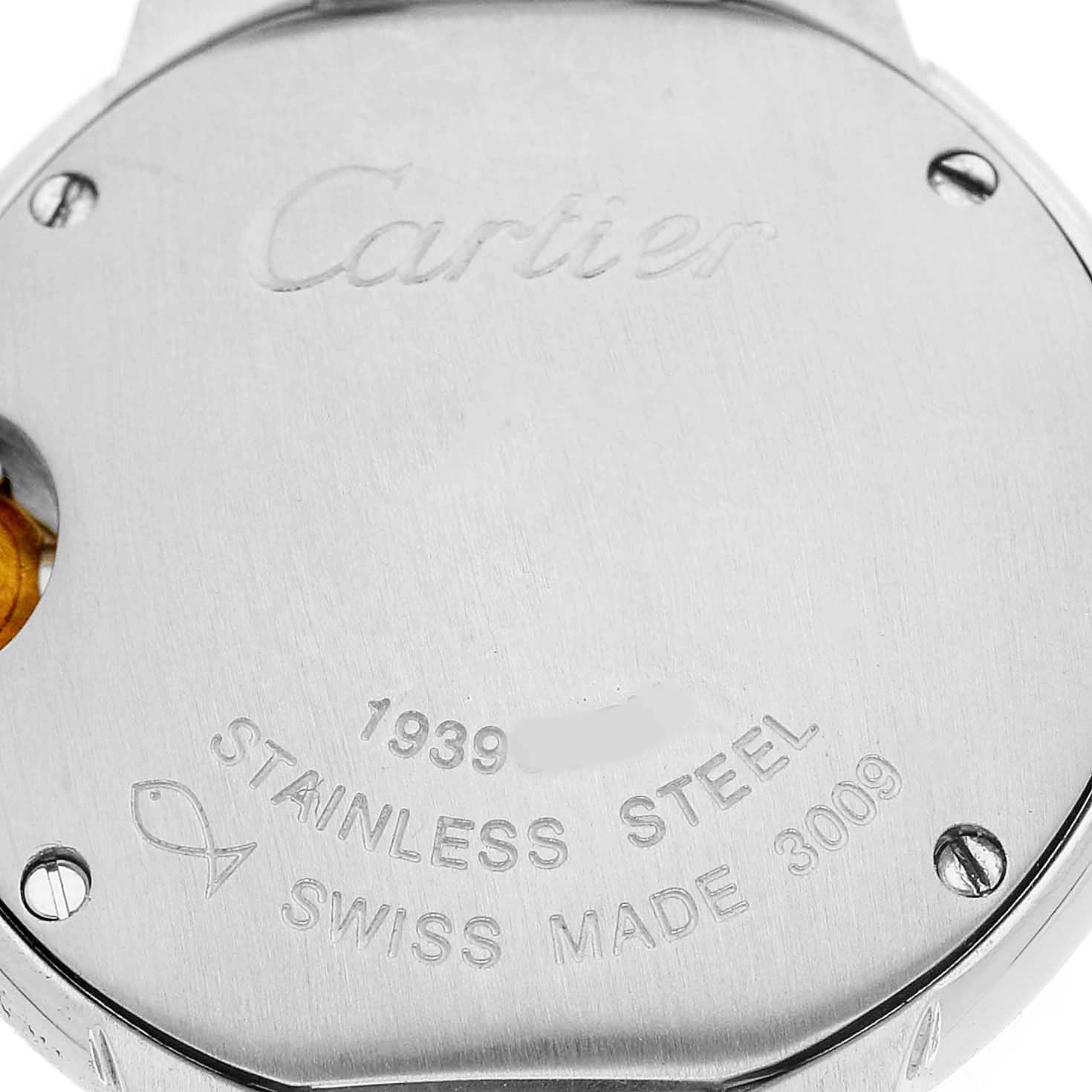 The image shows the back case of a Cartier Ballon Bleu W69007Z3 Women's Steel and Gold (two tone) Silver Dial watch, featuring engravings and screws.