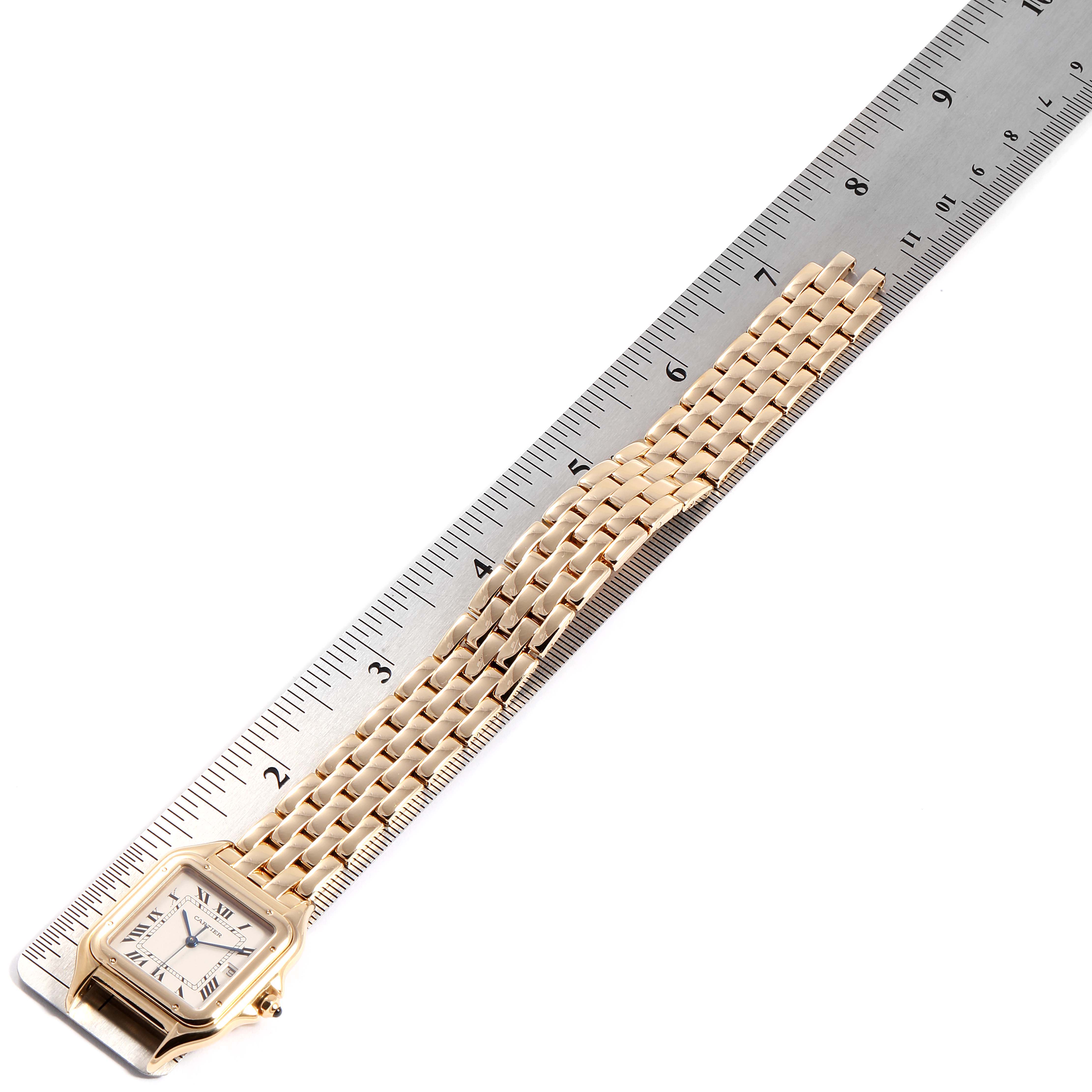 The image shows a top view of a Cartier Panthere W25014B9 Men's Yellow Gold Silver Dial W25014B9 Men's Yellow Gold Silver Dial watch with a ruler for scale, highlighting the bracelet and face.