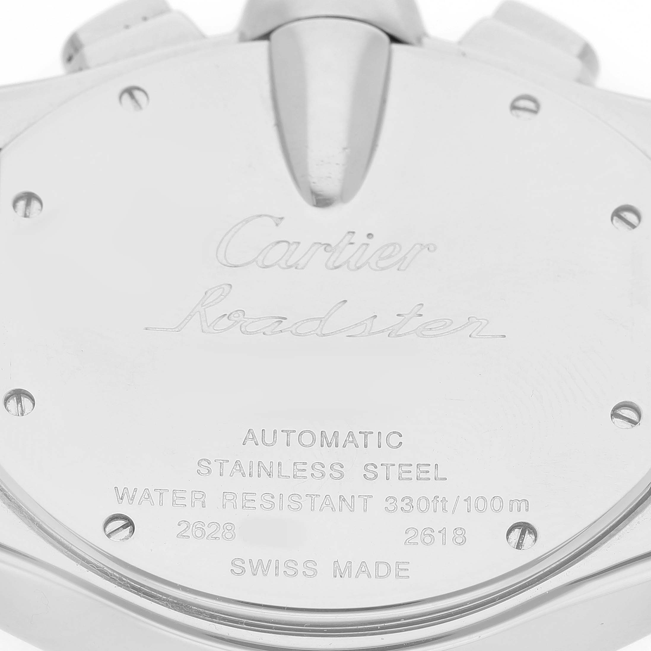 The image shows the back of a Cartier Roadster W62019X6 Men's Stainless Steel Silver Dial watch case, including engravings and the crown.