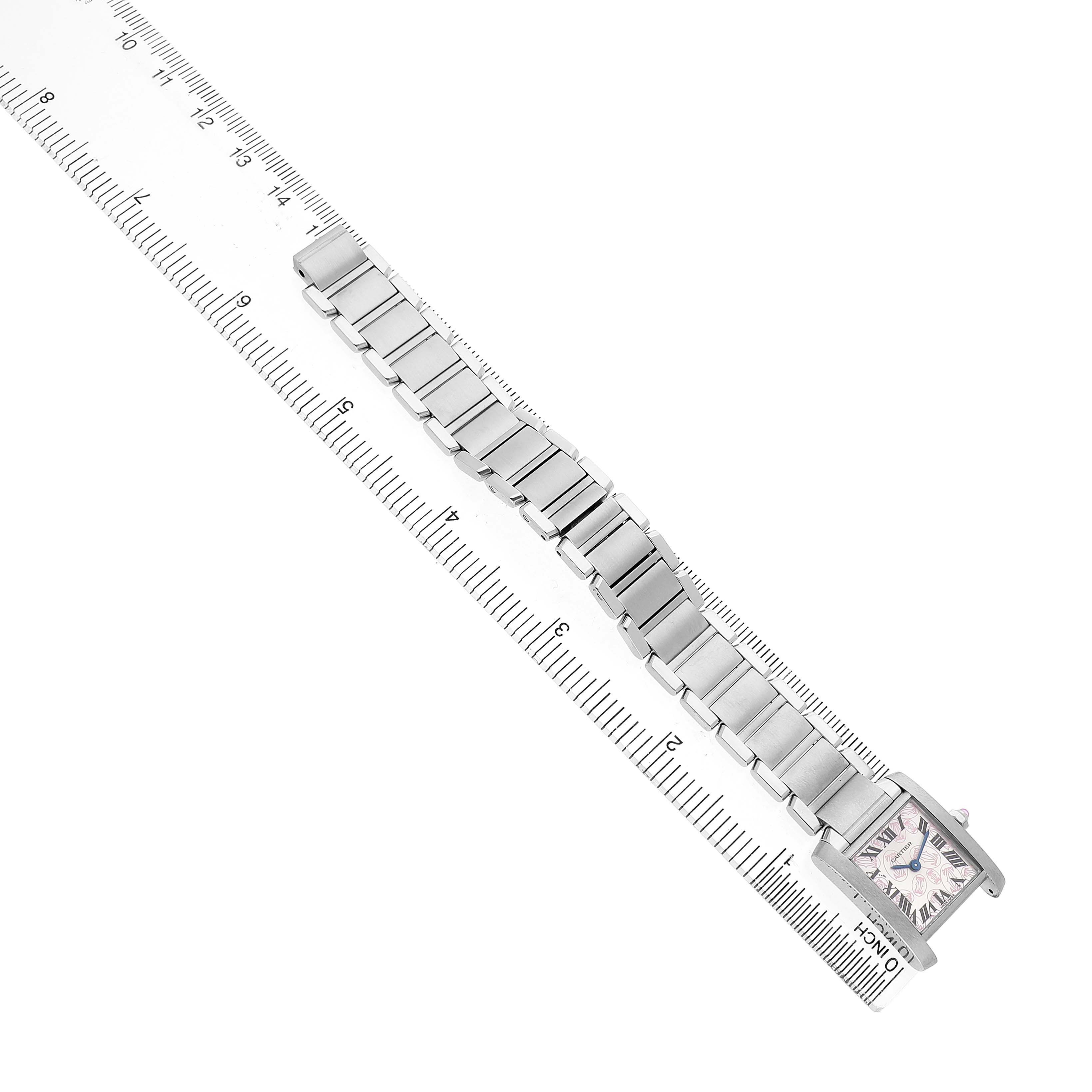 The Cartier Tank Française watch is shown from a top view, displaying its bracelet and face with a ruler for scale.