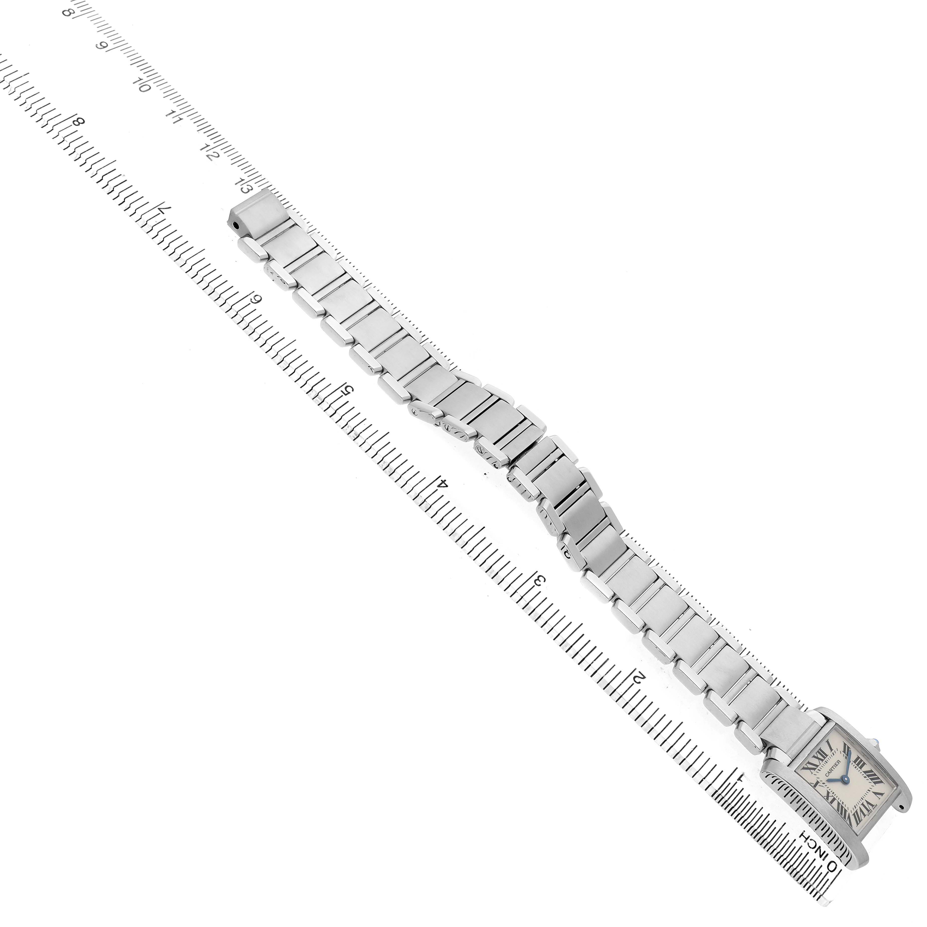 The Cartier Tank Francaise W51008Q3 Men's Stainless Steel Silver Dial watch is shown from an overhead angle, with a full view of its bracelet and face alongside a ruler.